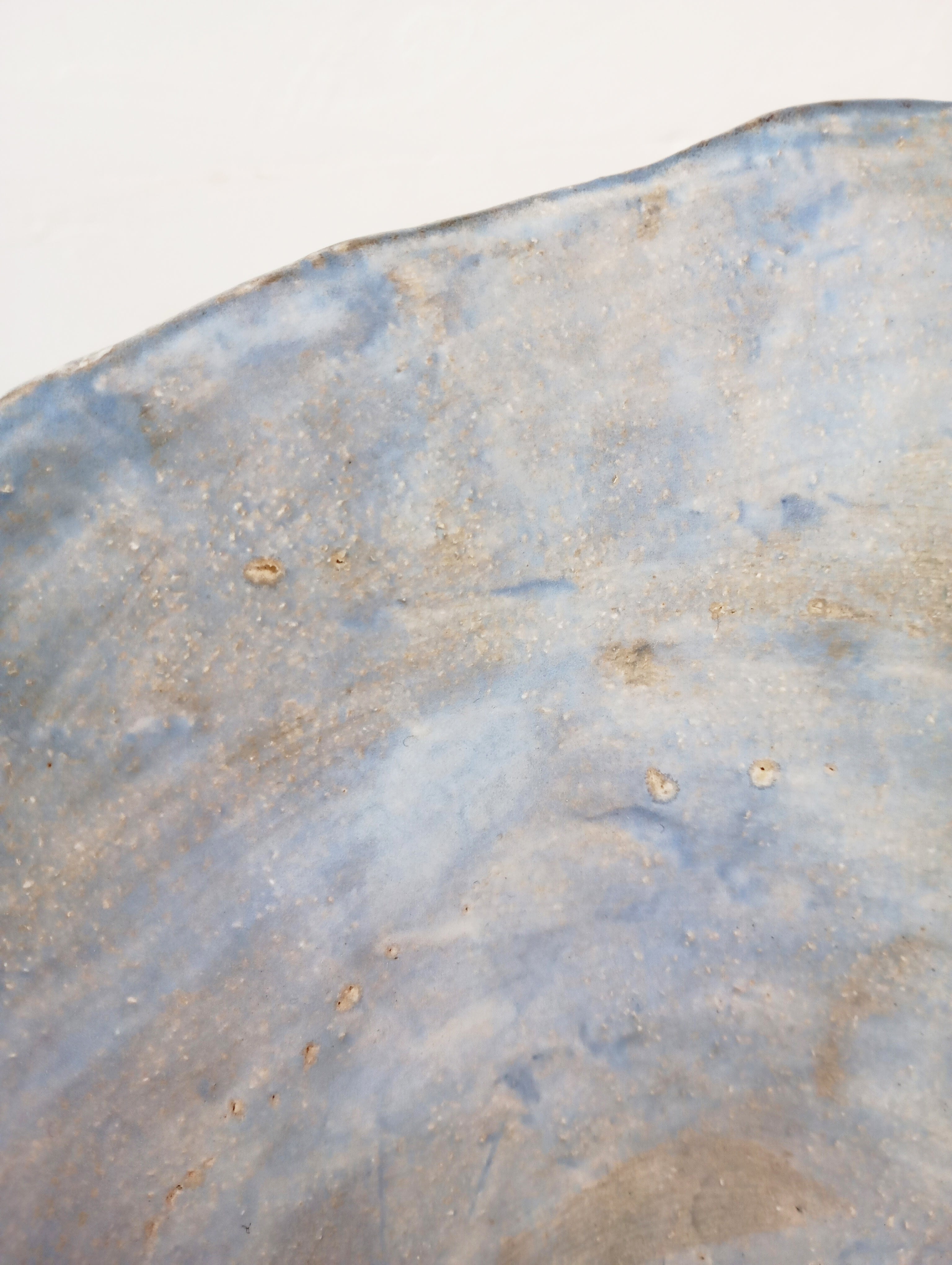 Coupe 22 — side angle showing textured blue ceramic surface