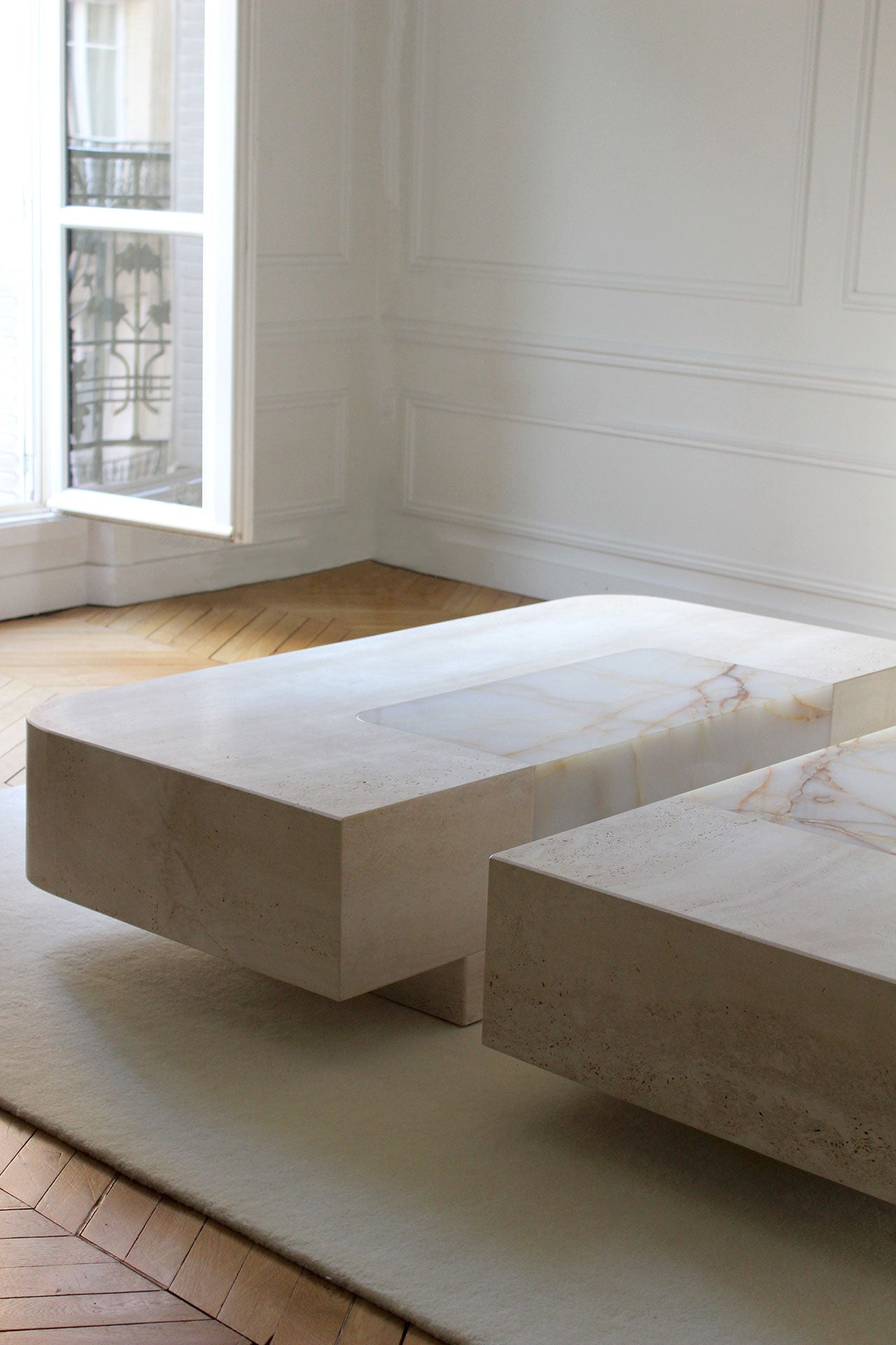 Baci Coffee Table — side angle showing light-colored stone surface