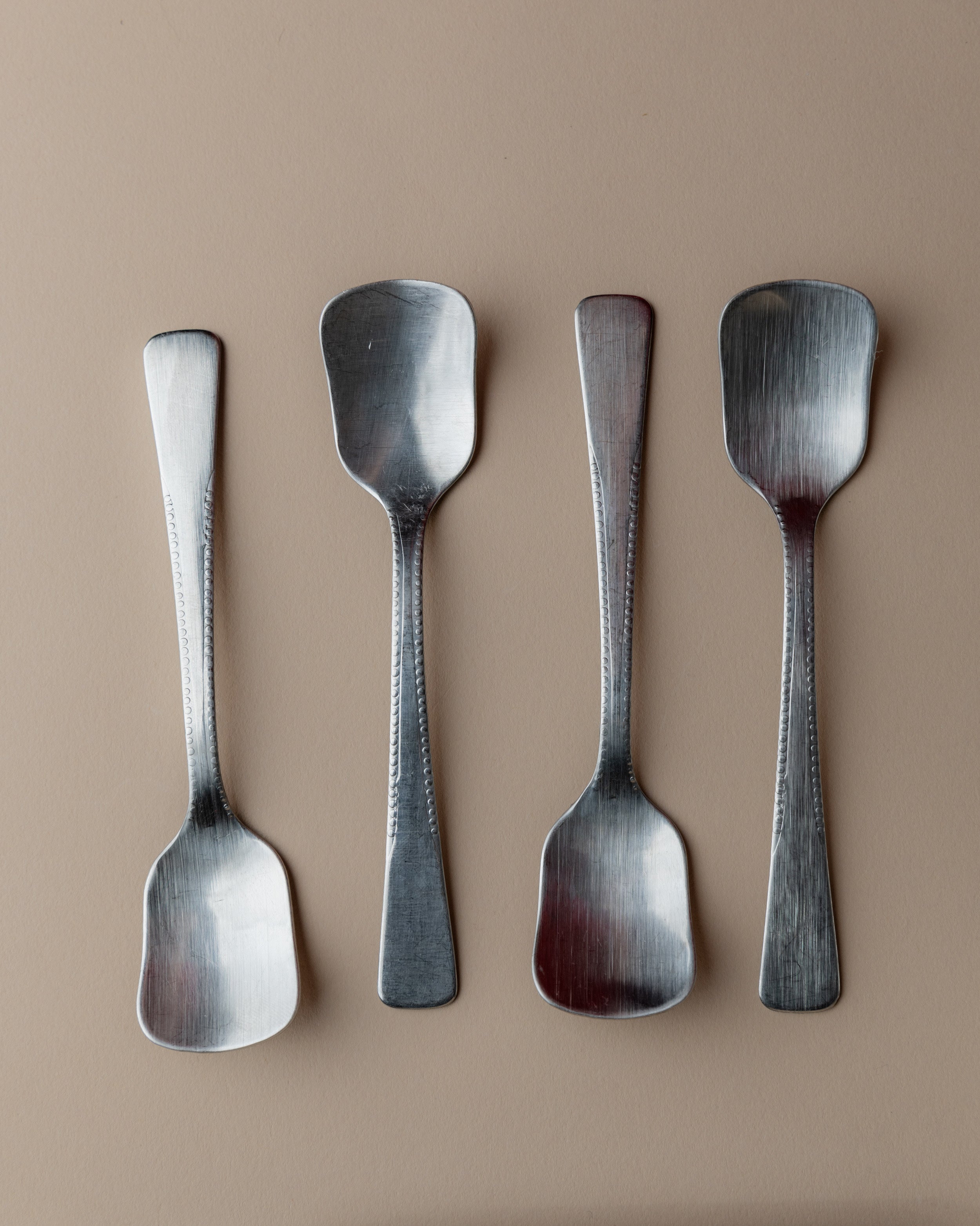 Vintage 1970s Ice Cream Serving Set for 4, Stainless Steel Cups, Spoons, Tray, Scoop — back view of four stainless steel spoo