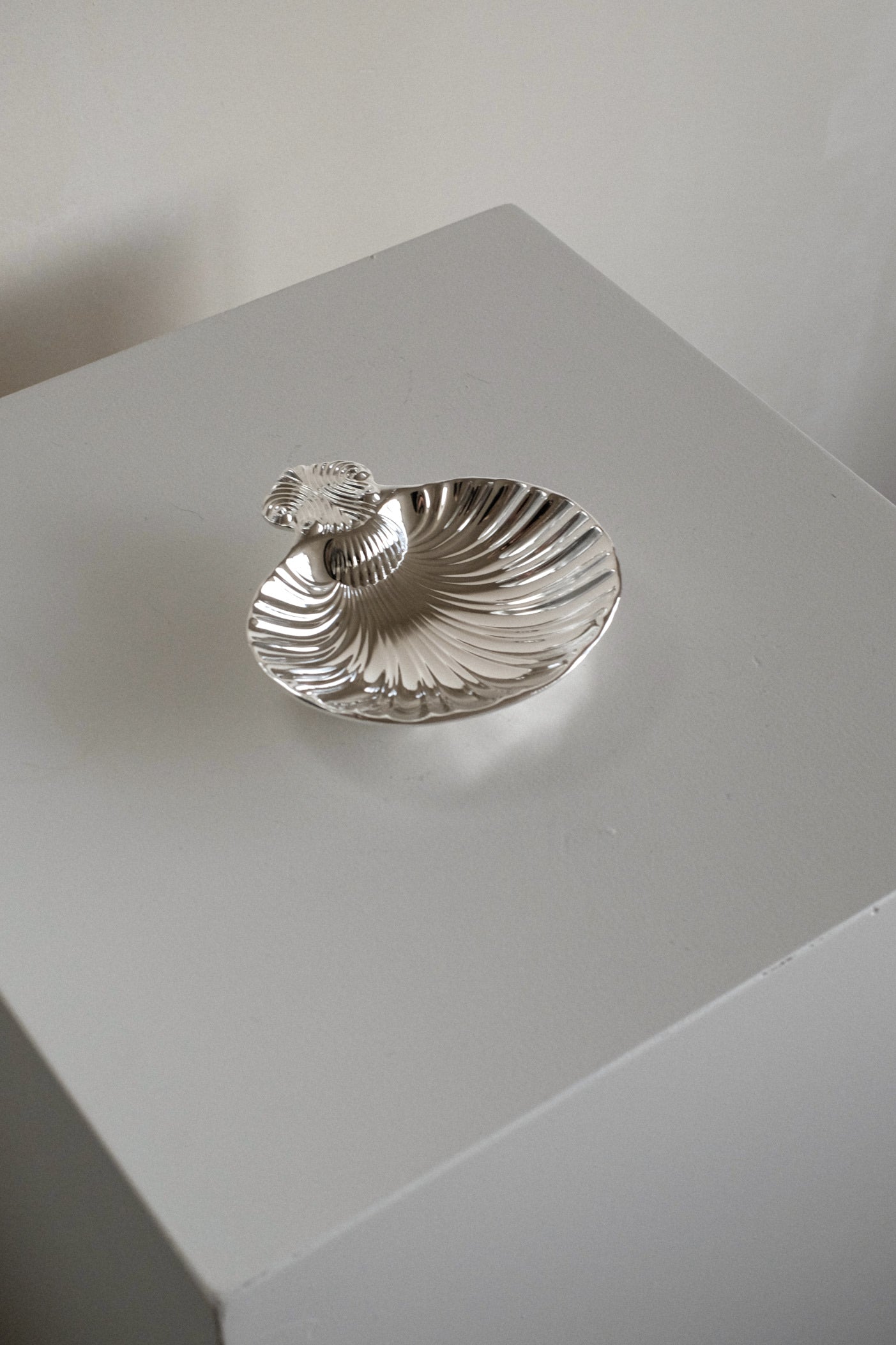 Silver-Plated Shell Tray — angled view on white pedestal