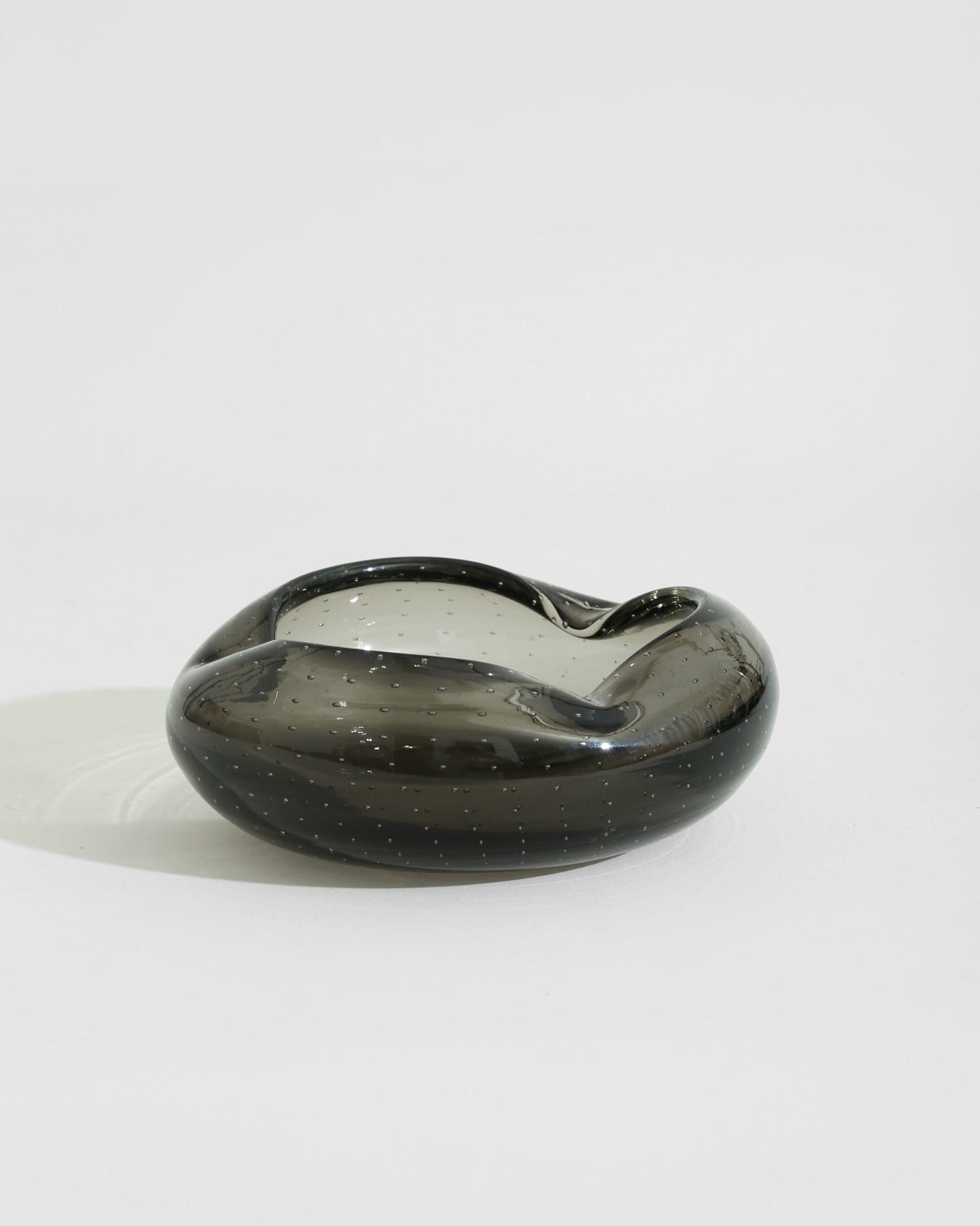 Italian Glass Catchall — close-up of dark glass surface with bubbles