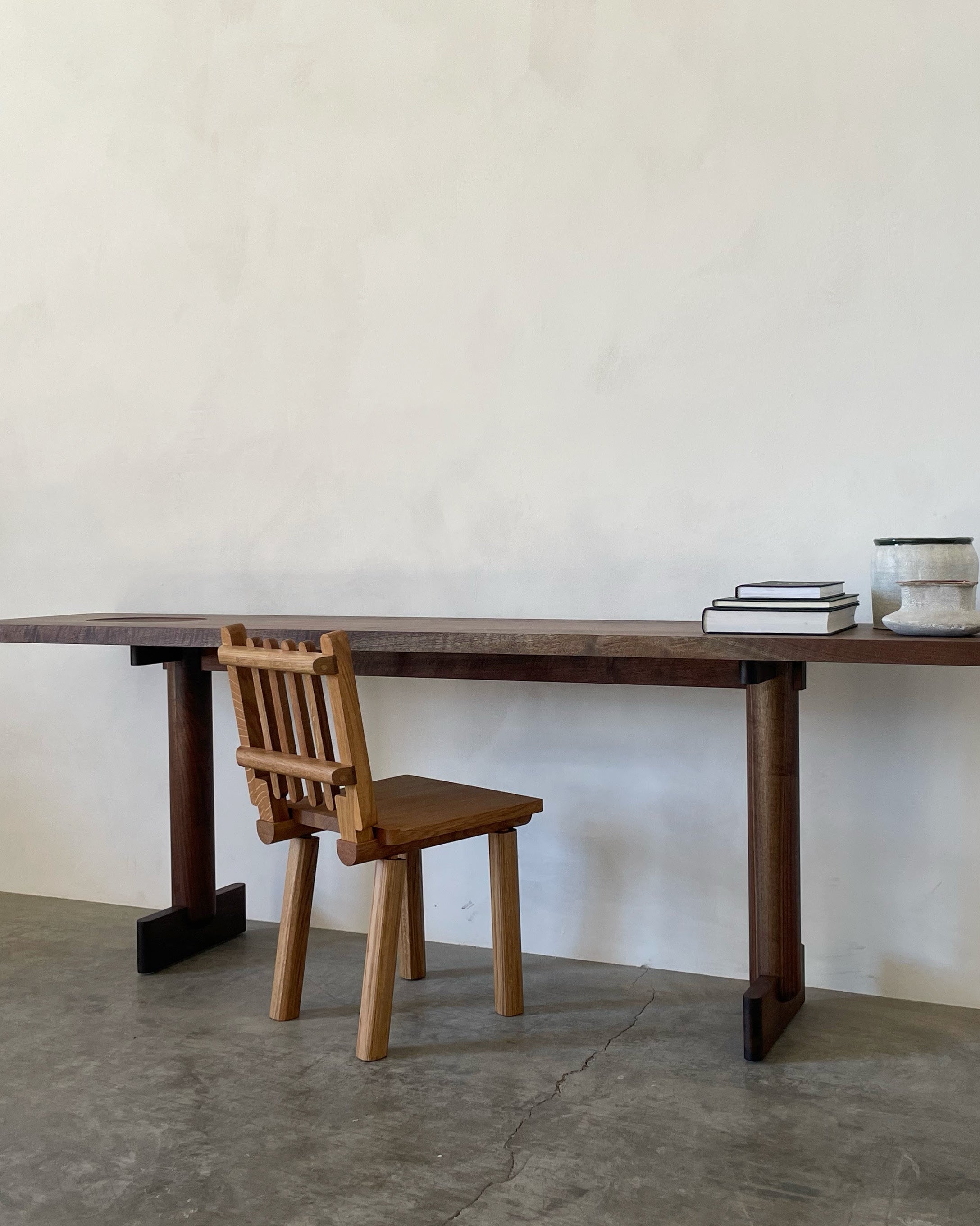 Taverne Chair — side view against minimalist wall setting