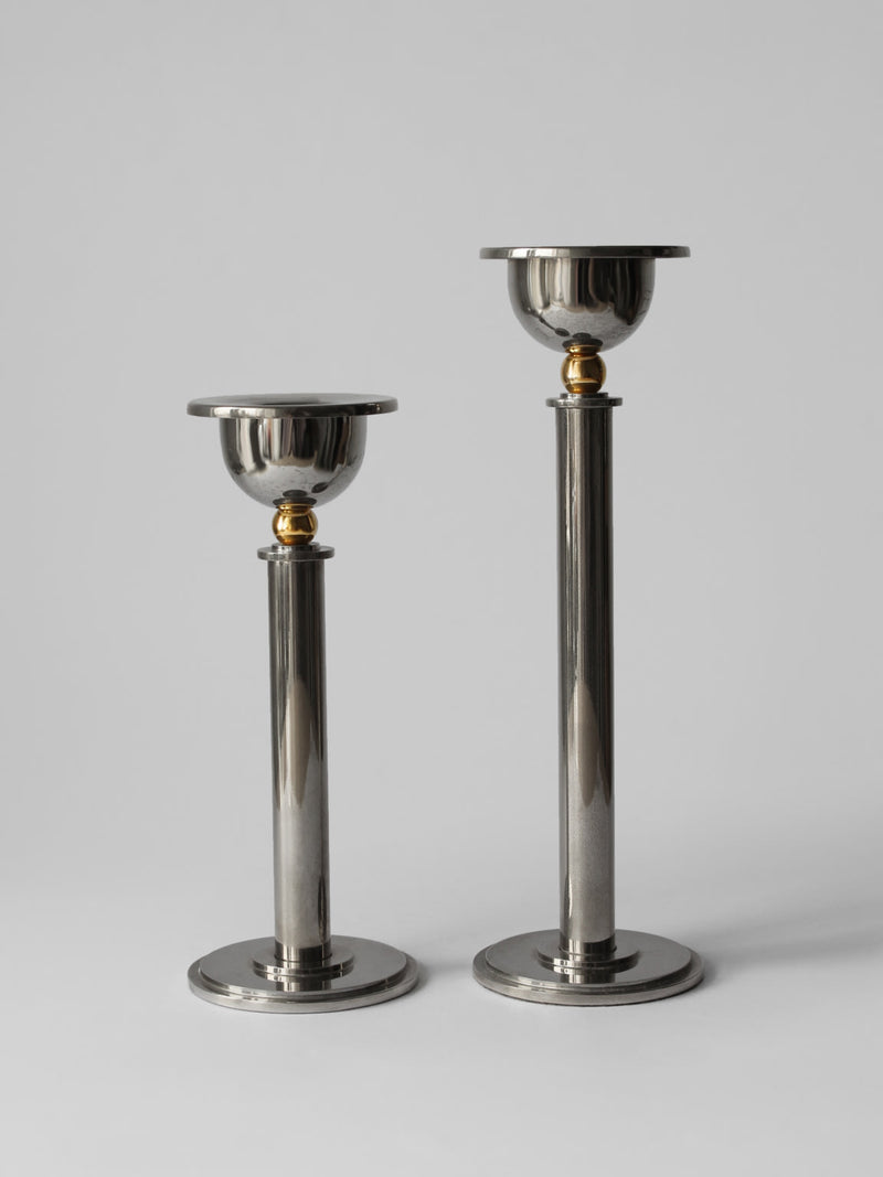 Set of two silver plated candle holders with brass accents