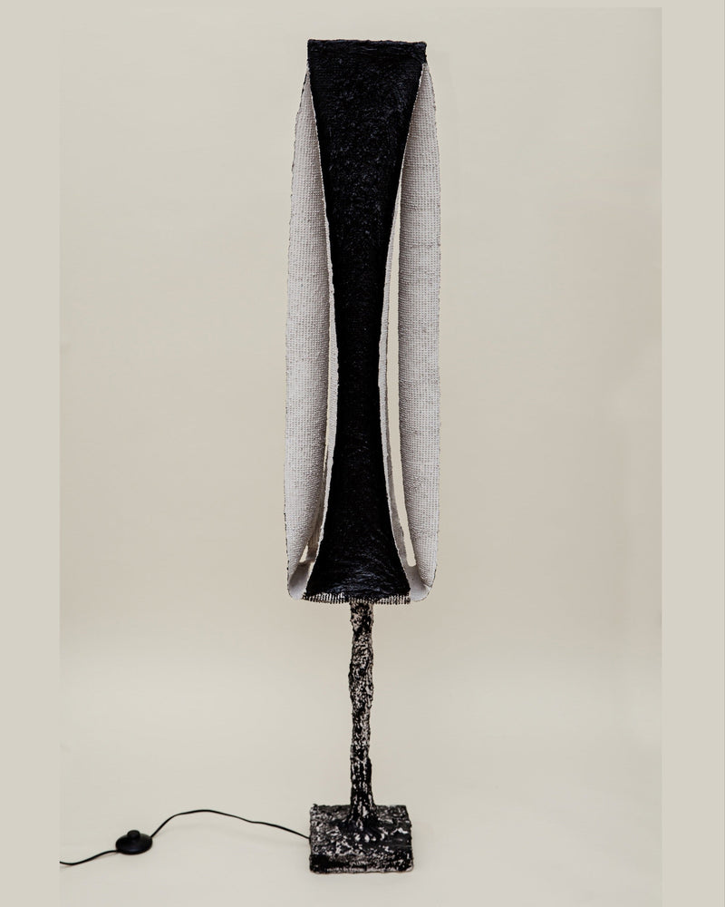 Rebirth I floor lamp with textured black shade and sculptural base