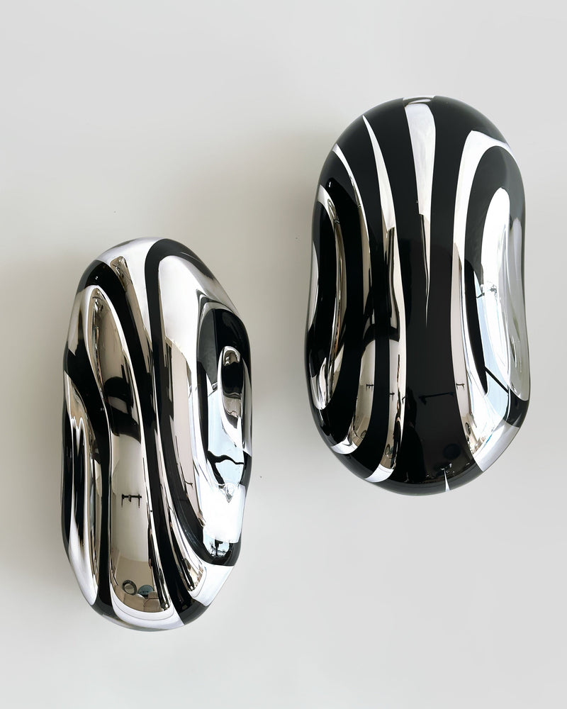 Flow Line IV — close-up of polished black and silver surfaces