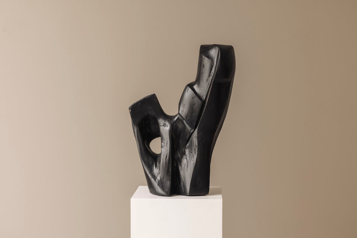 Abstract sculpture in solid dark stained wood dating from the 1950s. — in context