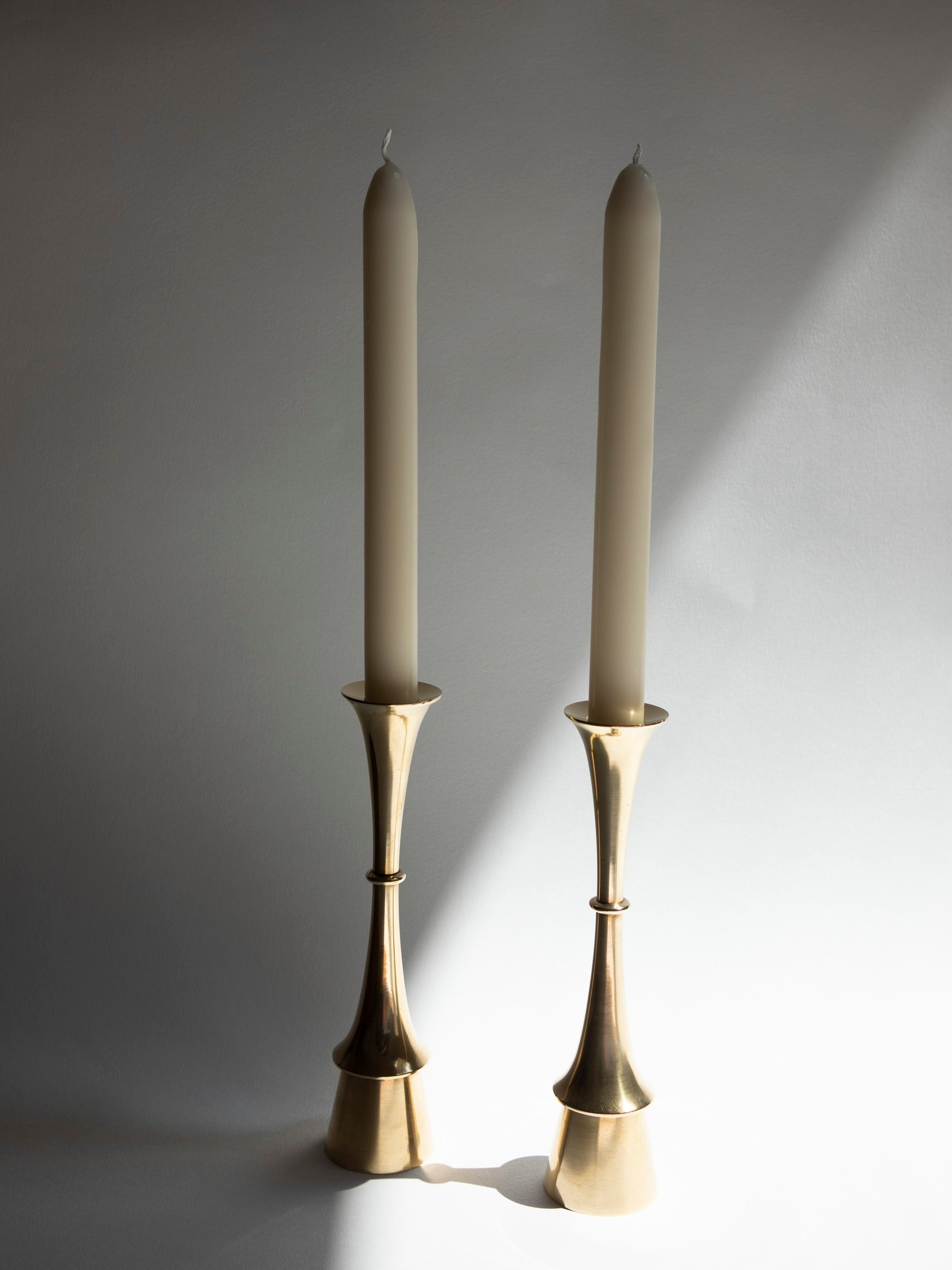Pair of Fluid Form Danish Modern Solid Brass Candlesticks | c. 1960s — side angle