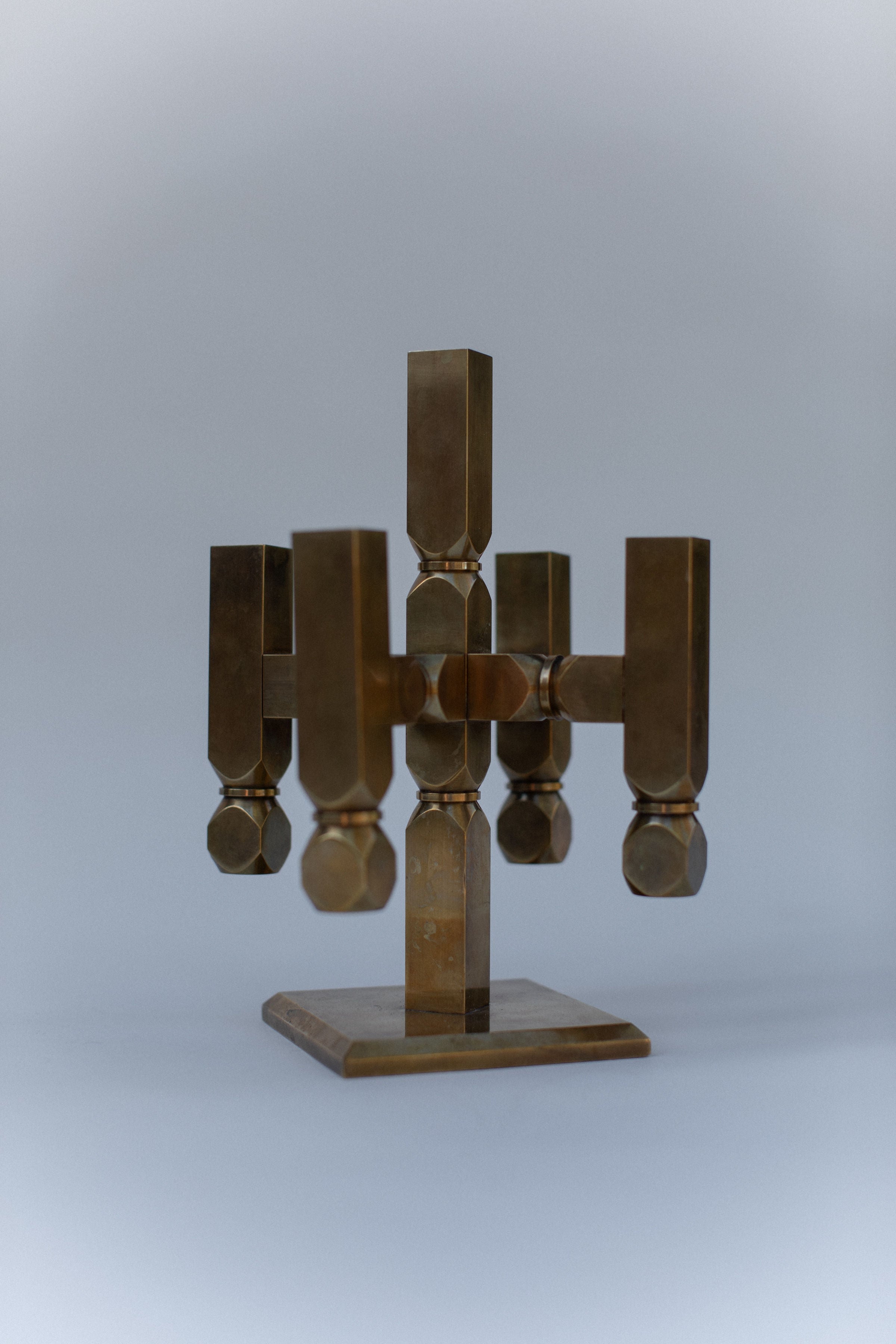 Brutalist brass candelabra with geometric vertical holders on base