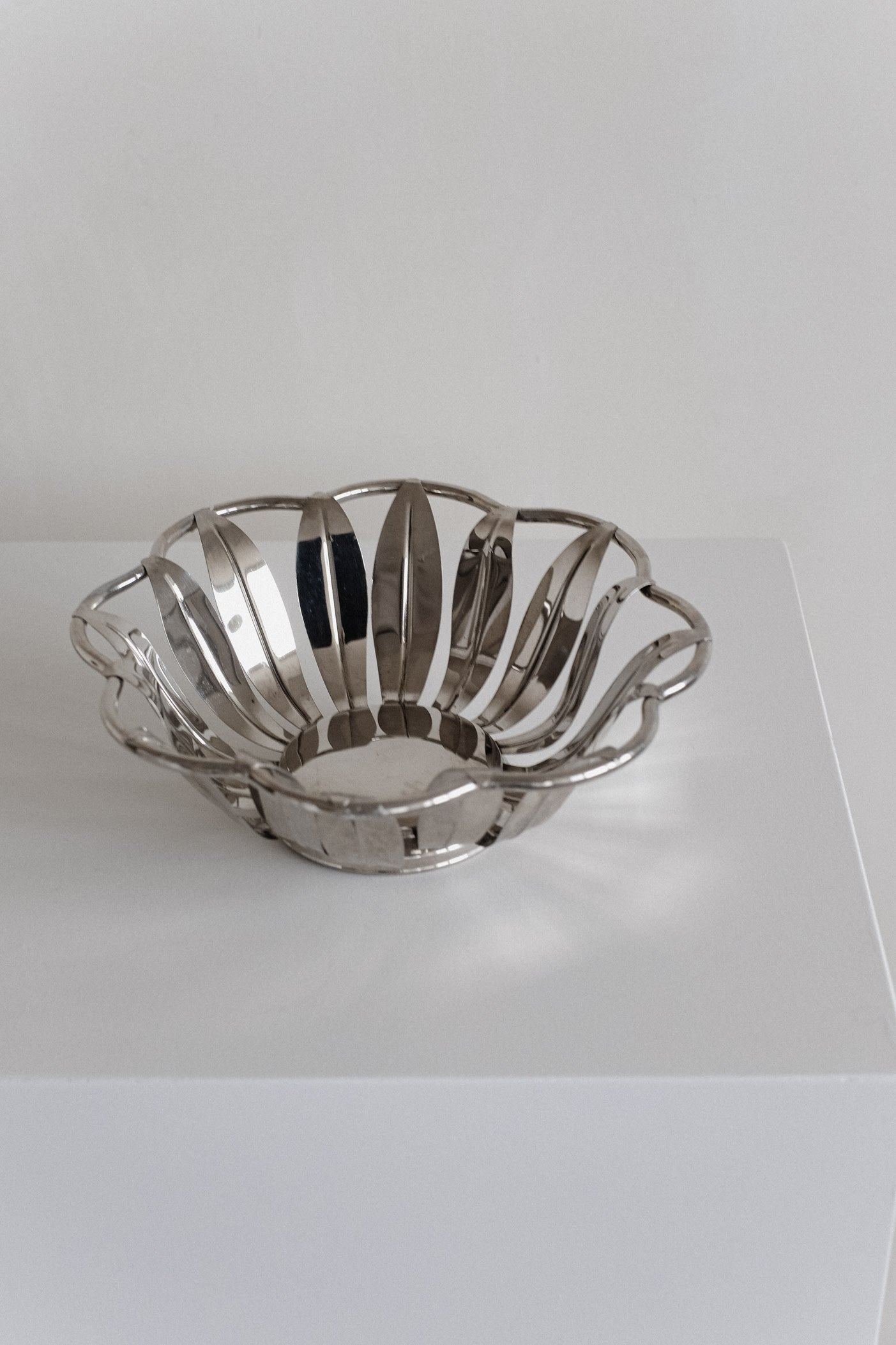 Silver-Plated Bread Basket — angled view on white pedestal