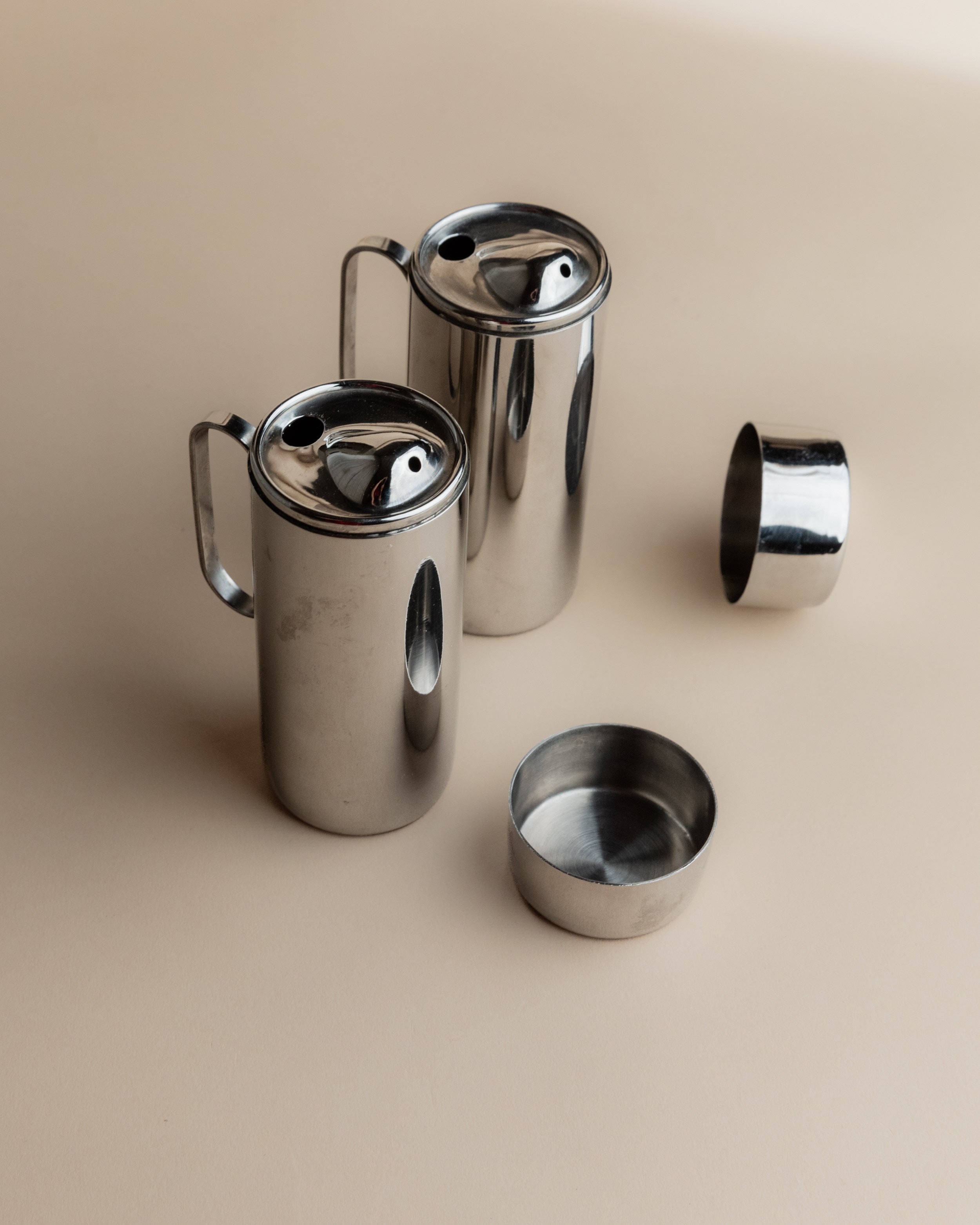 Disassembled 1980s stainless steel oil vinegar set components