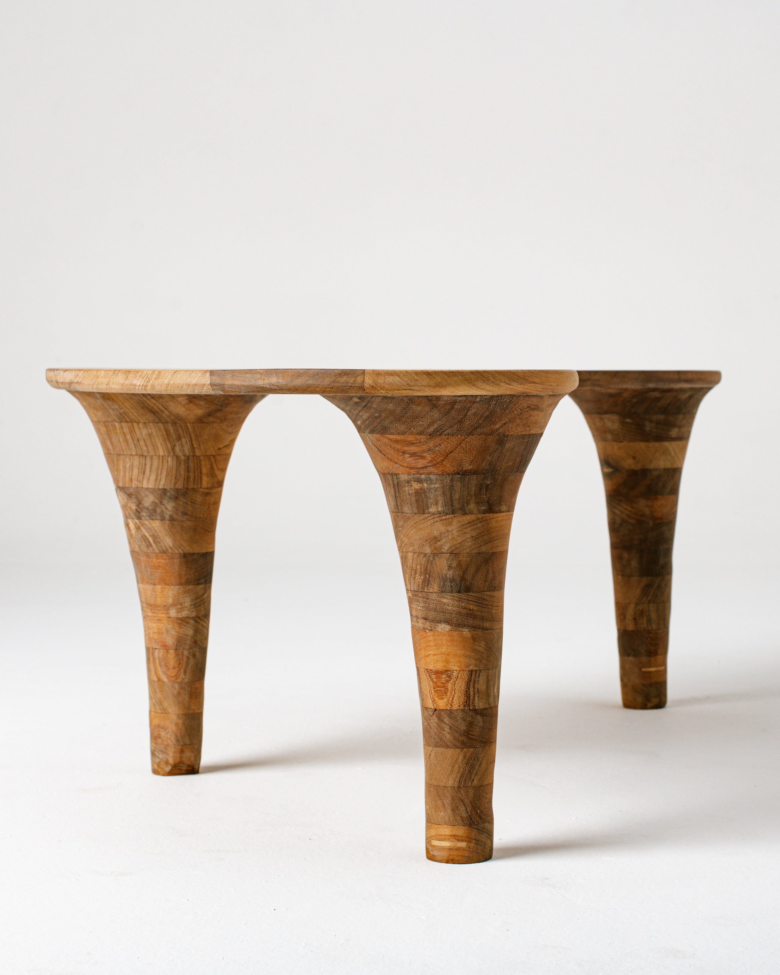 Sculptural wooden coffee table with curved tapered legs and organic form