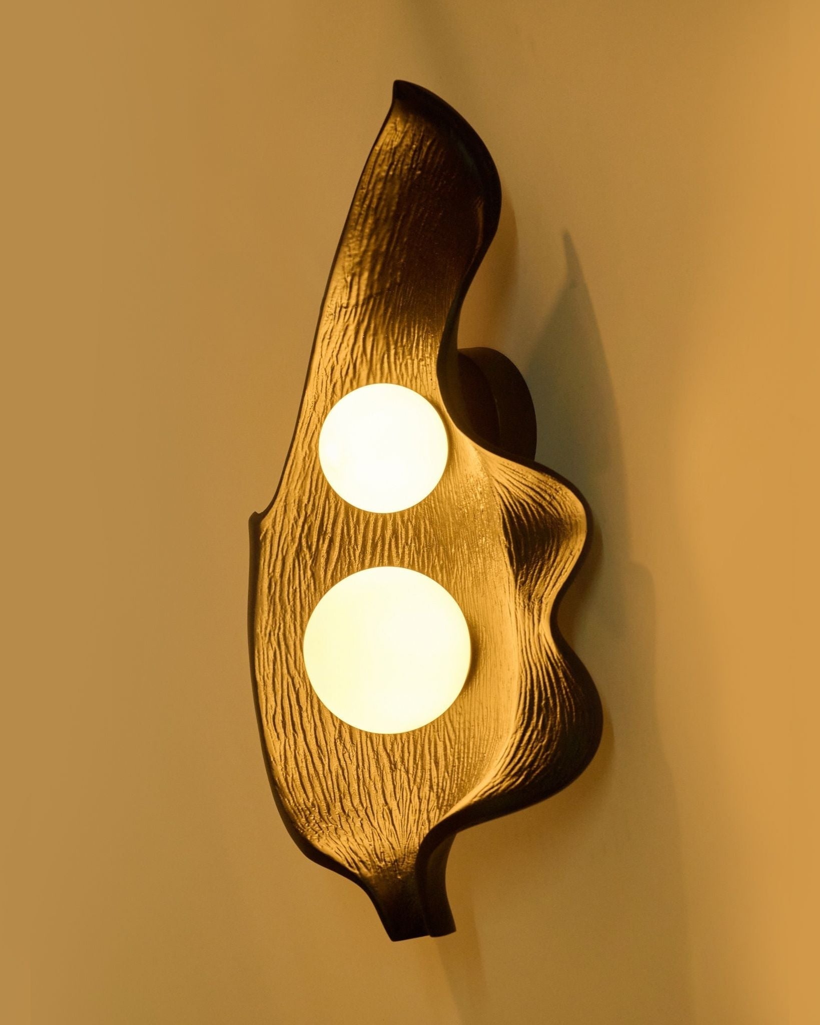 Foliage Wall Light — mounted on wall with warm glow