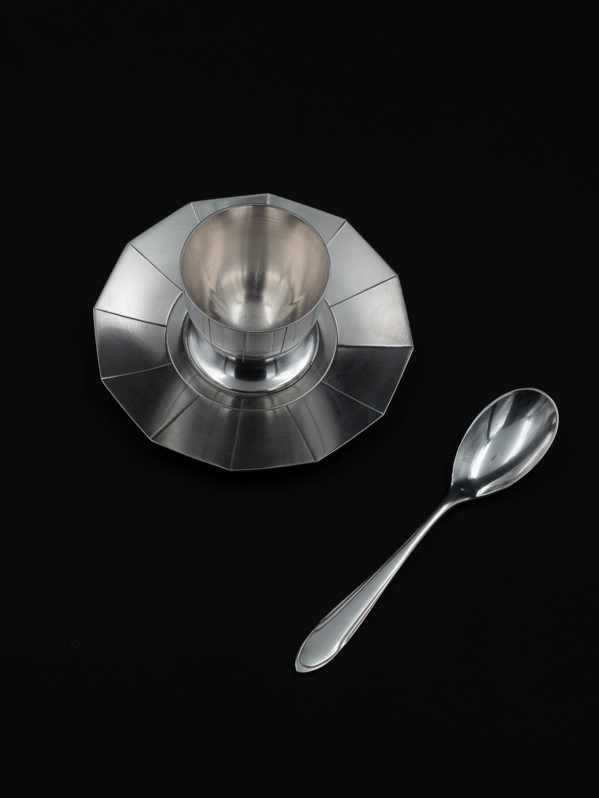 Art Deco Egg Cup & Spoon by Ercuis, France, c. 1930s — top view on black background