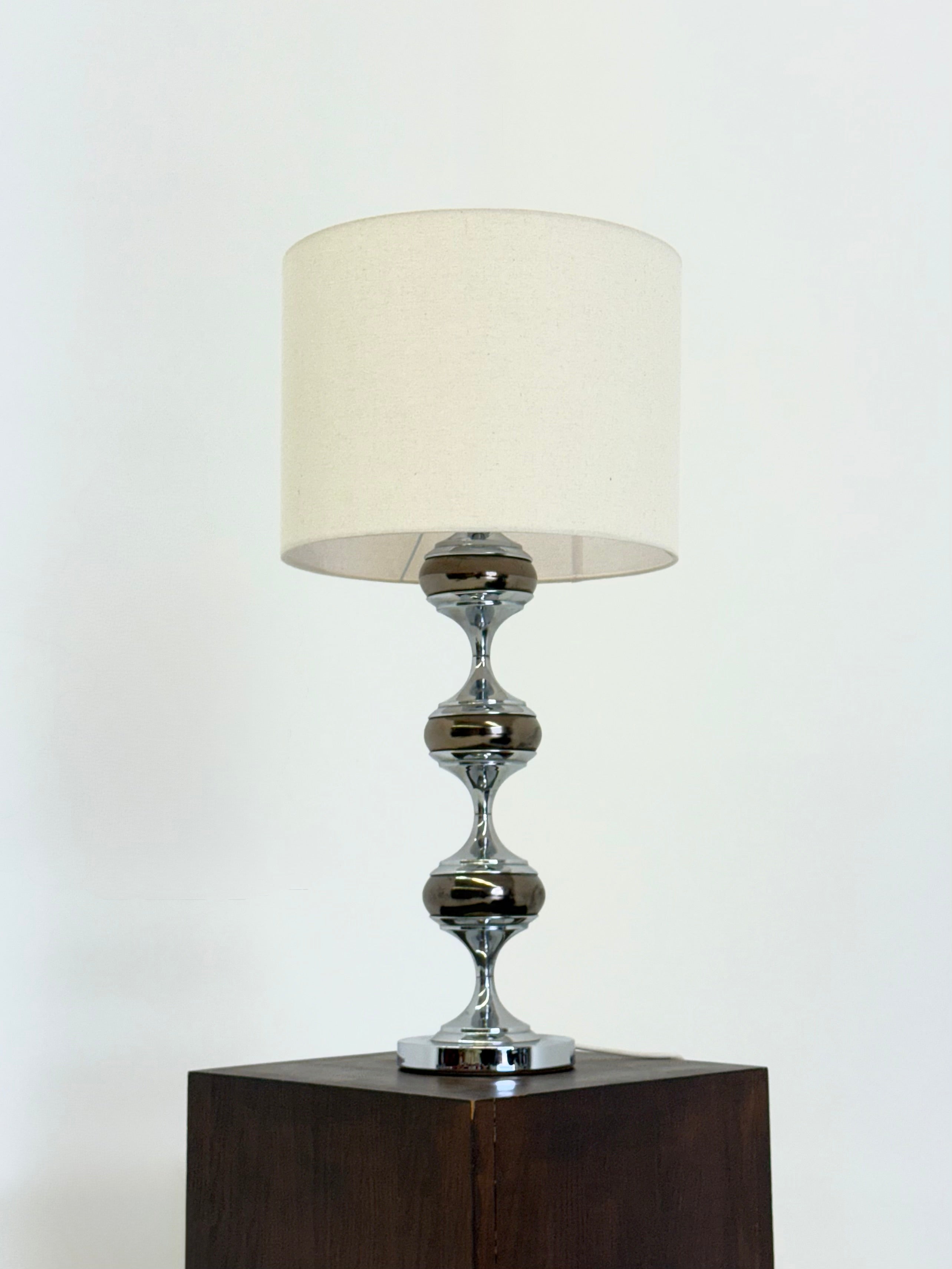 Space Age table lamp with chrome sculptural base — lifestyle setting