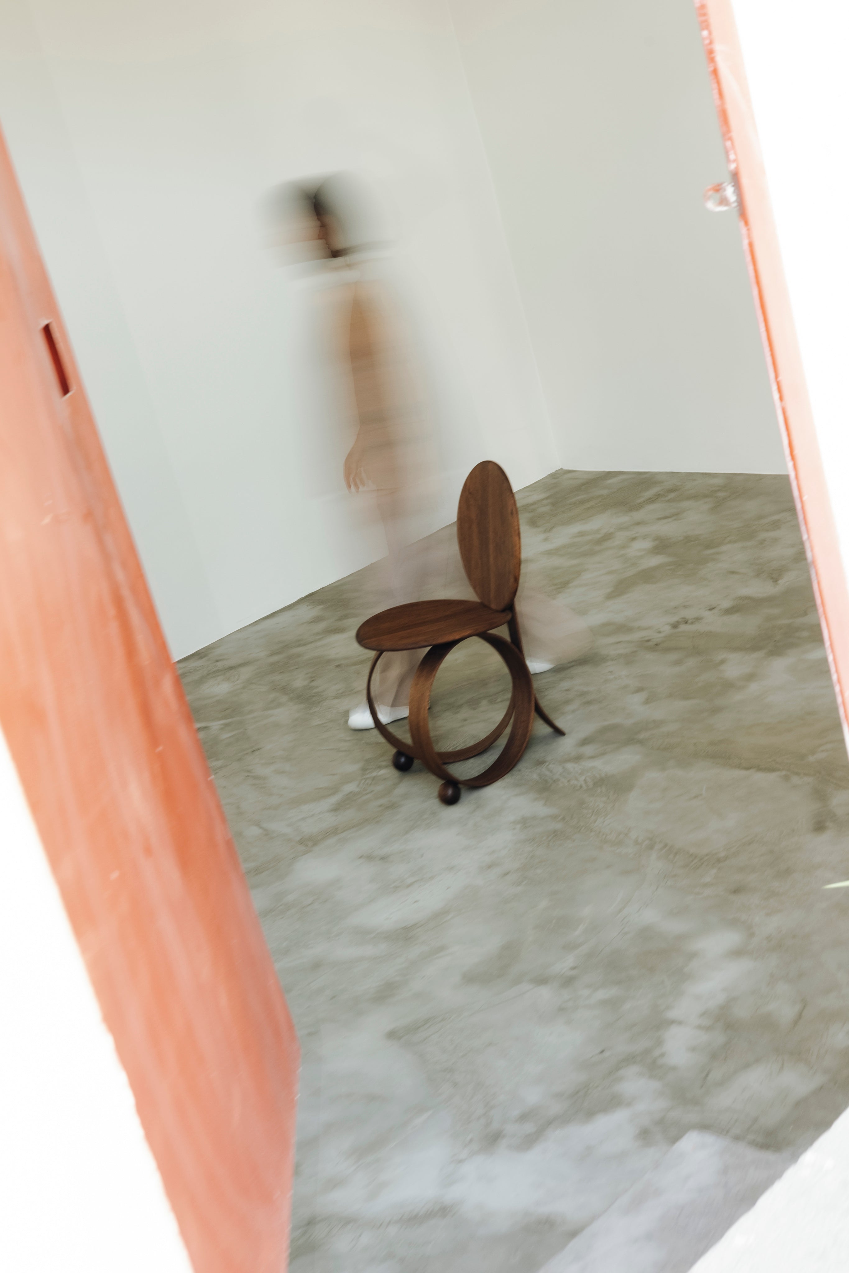 Yara' Chair — wooden chair in minimalist room with motion blur