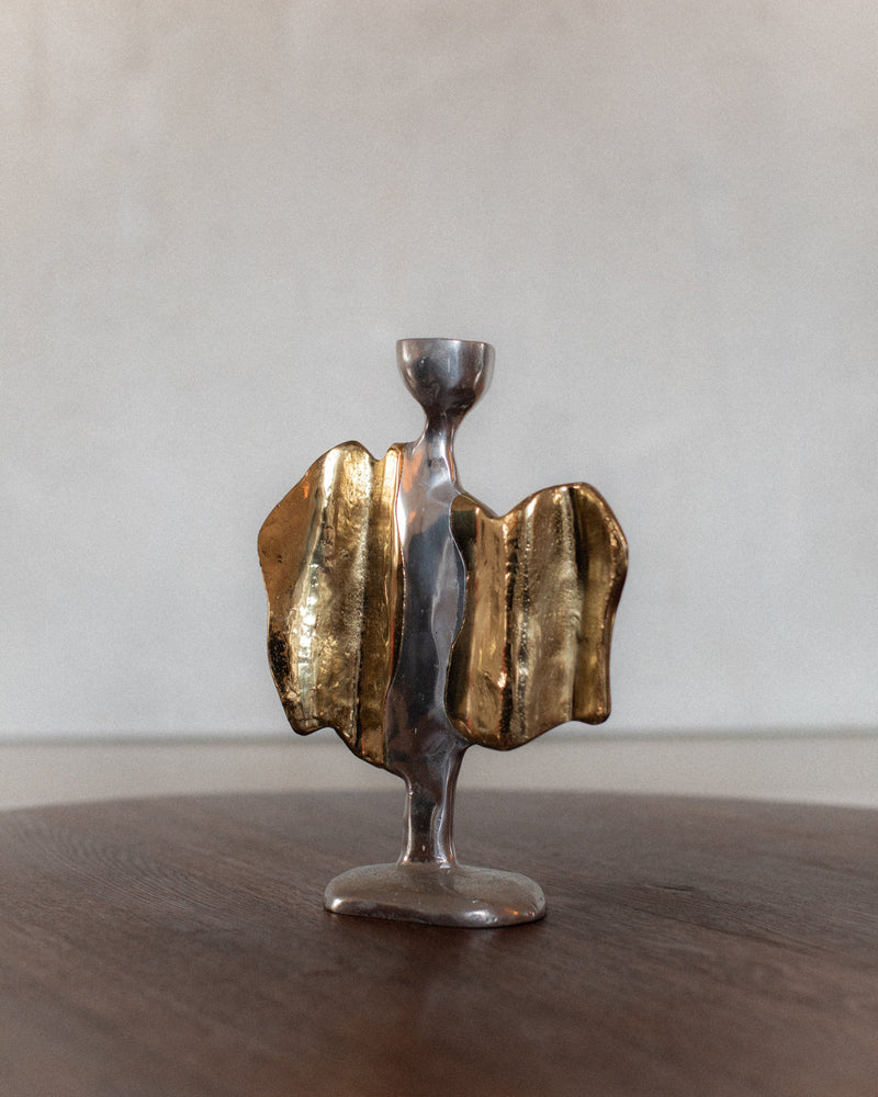 Sculptural brass and pewter candleholder with flowing metallic form