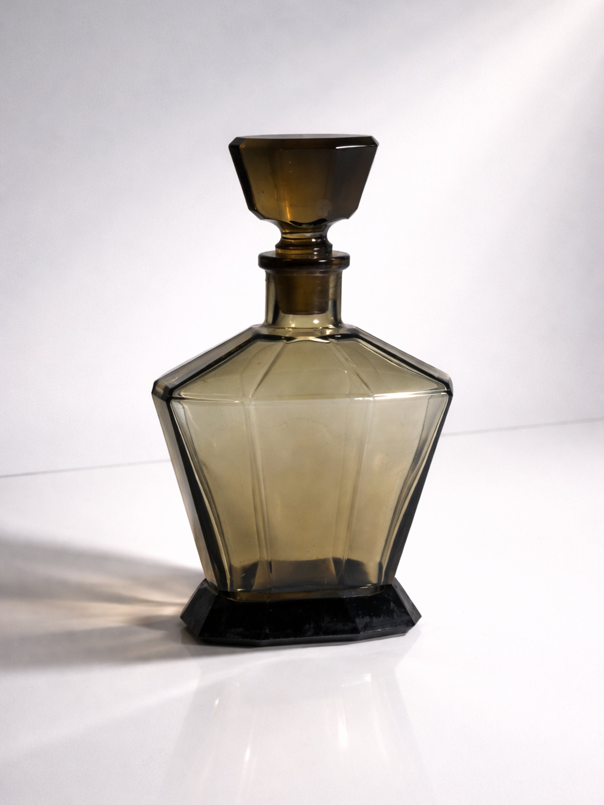 Bohemian Art Deco Decanter - 1930s — close-up of amber glass and black base