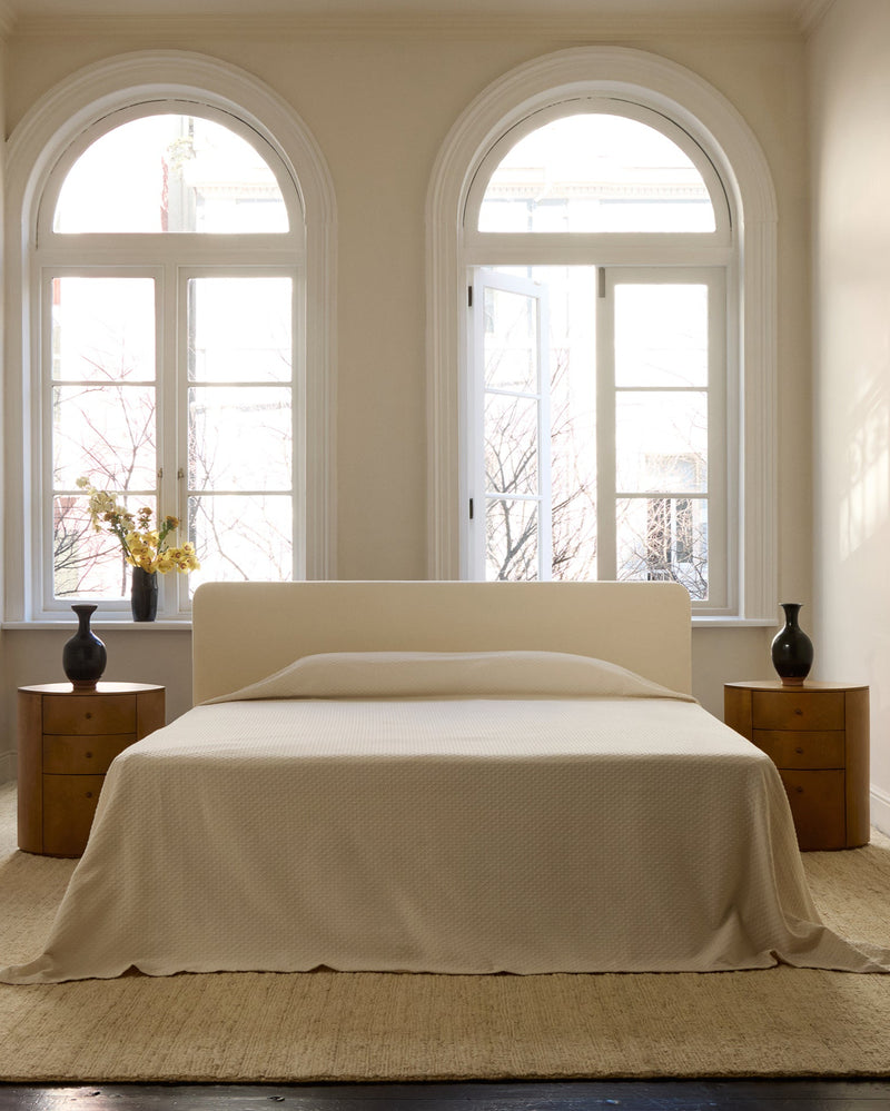 Observer nightstand styled with arched windows in minimalist bedroom