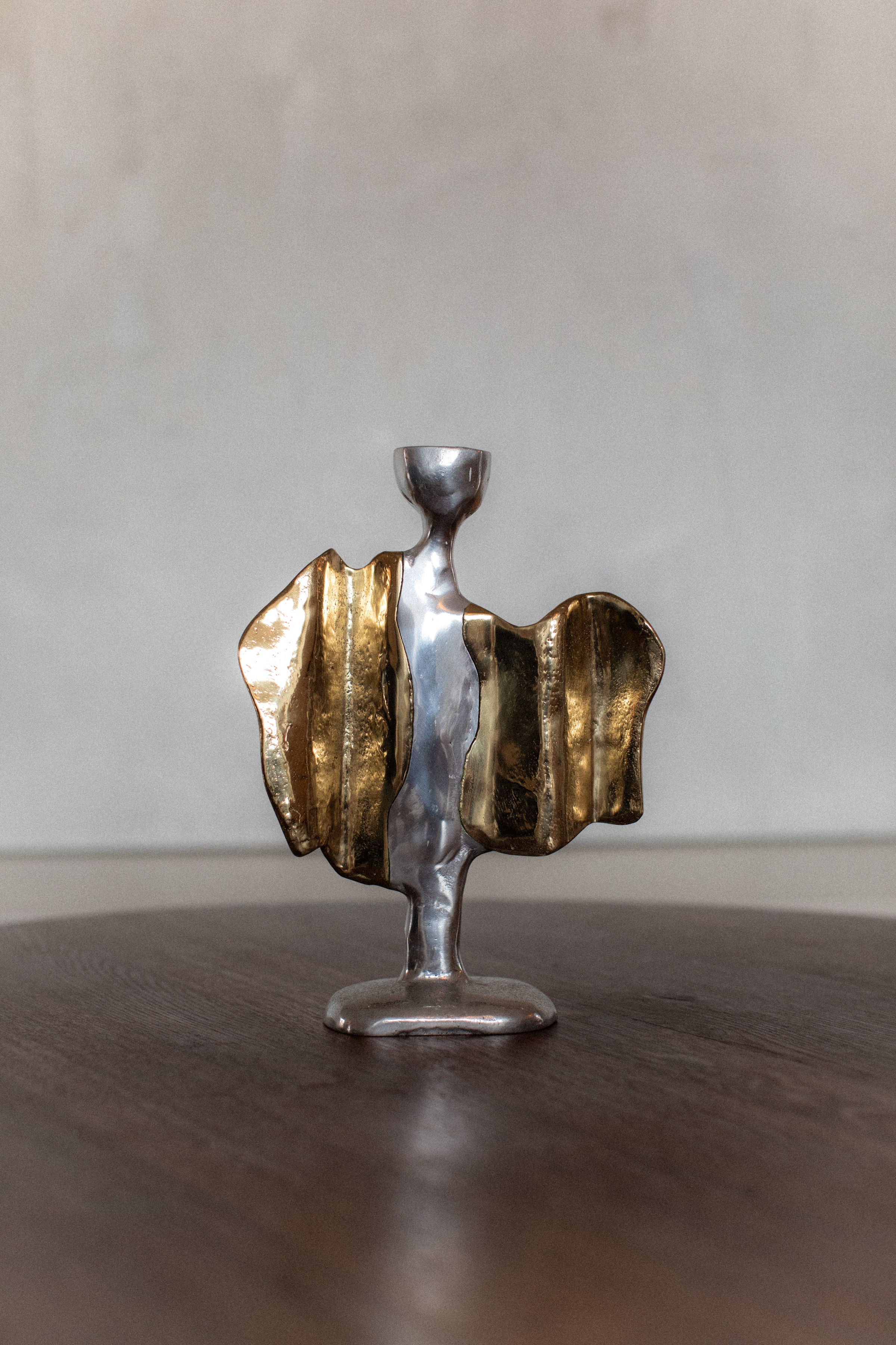 Modern sculptural candleholder with gold textured wings detail