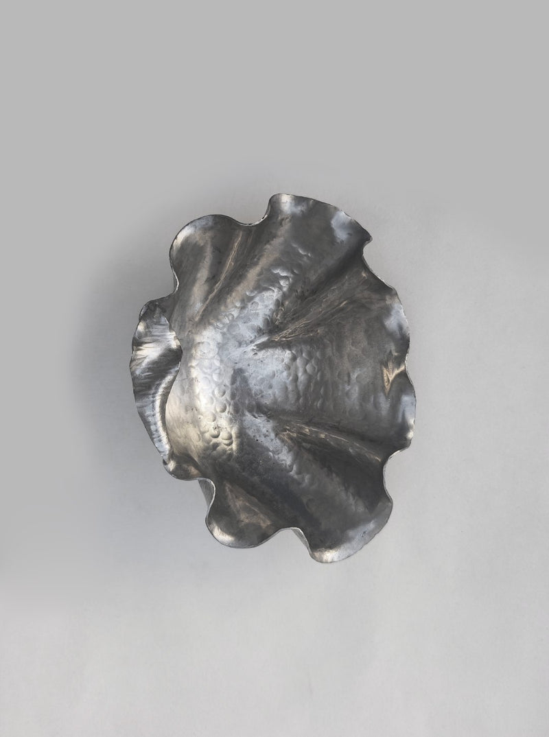 Pewter shell-shaped vide poche showing curved sculptural detail