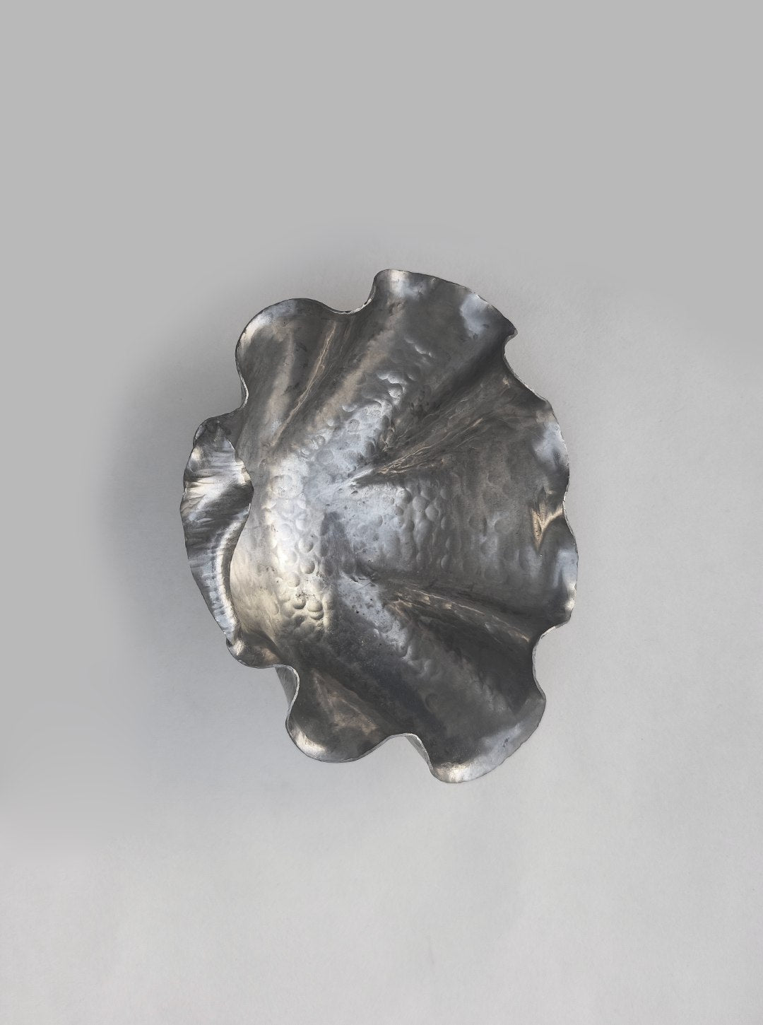 Pewter shell-shaped vide poche showing curved sculptural detail