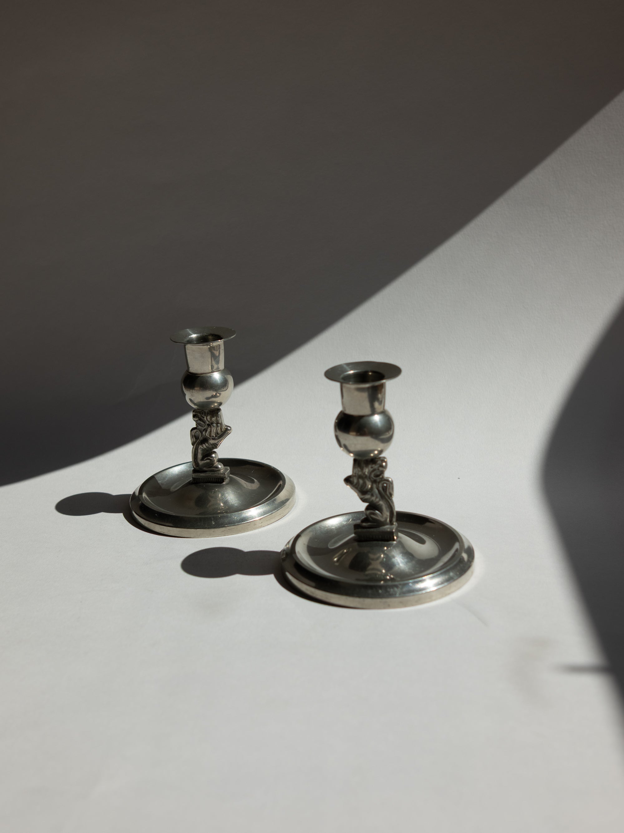 Pair of Swedish Grace Art Deco Pewter Lion Candlesticks by Eskilstuna Metallindustri, 1932 — lifestyle setting