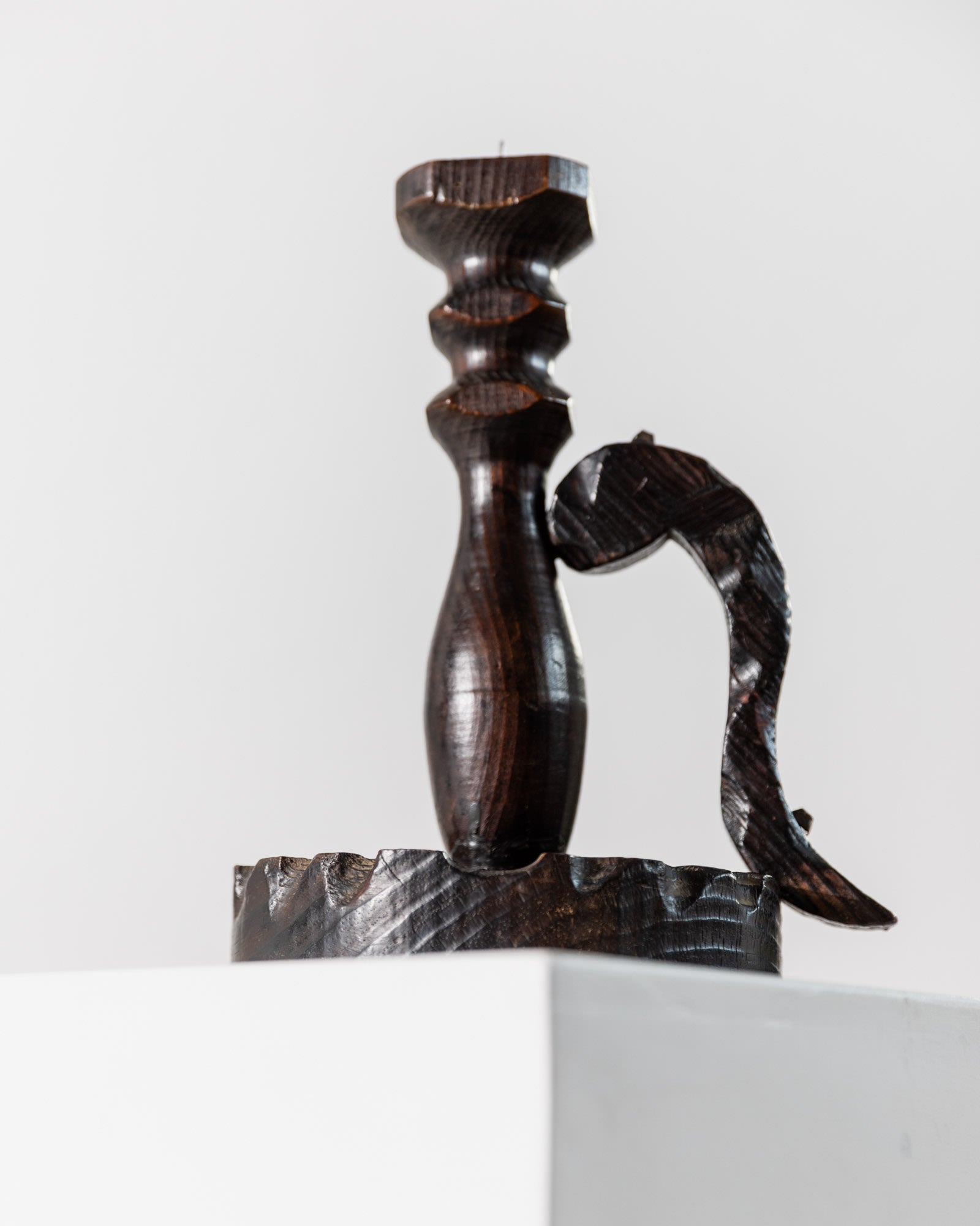 The 1960s Wooden Candleholder in Handcarved Dark Wood by Bottega Jacobs features a carved fish-shaped handle and dark finish, bringing mid-century charm to any space when displayed against a light background.