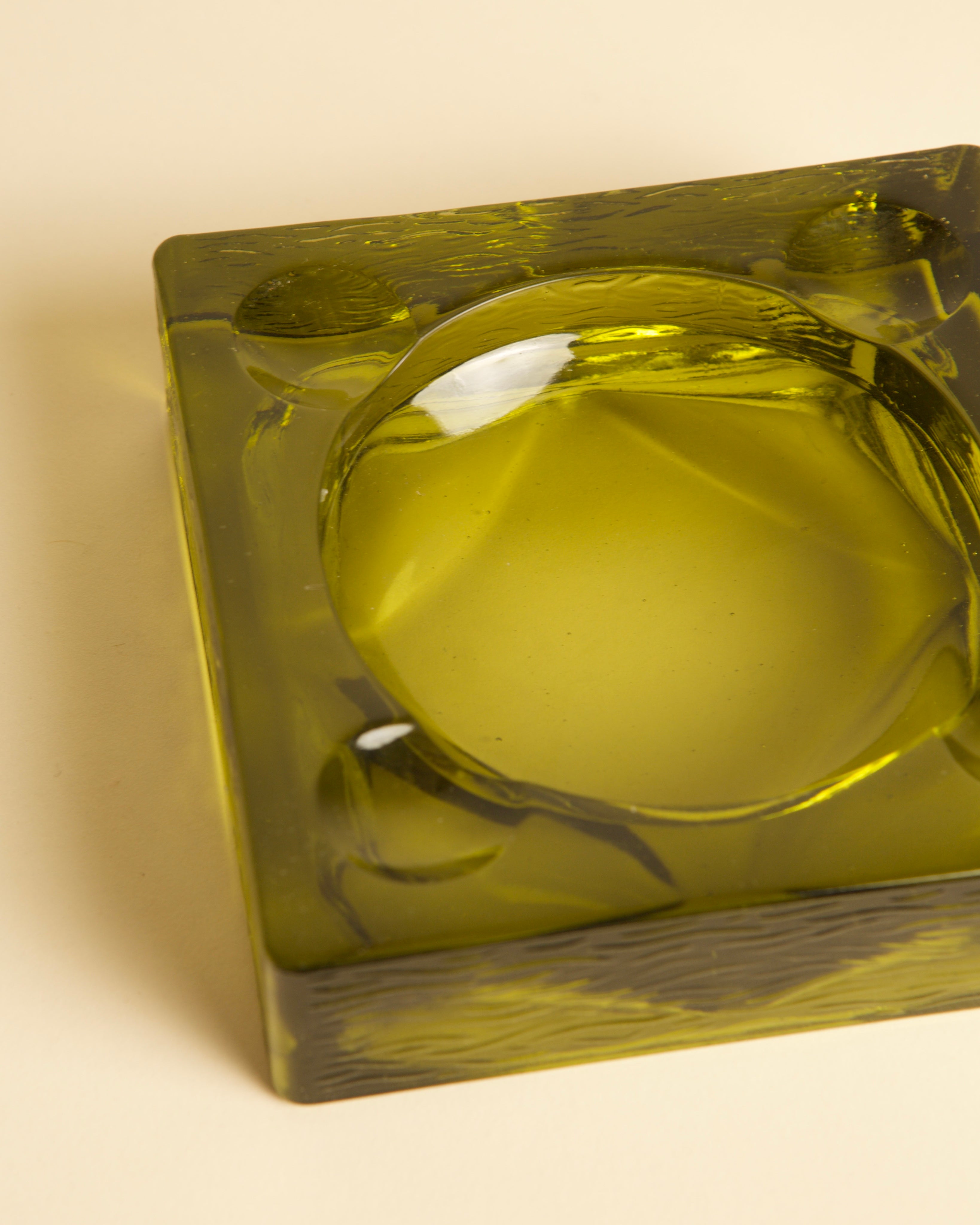 Close-up detail of Italian dark green glass ashtray from 1970s