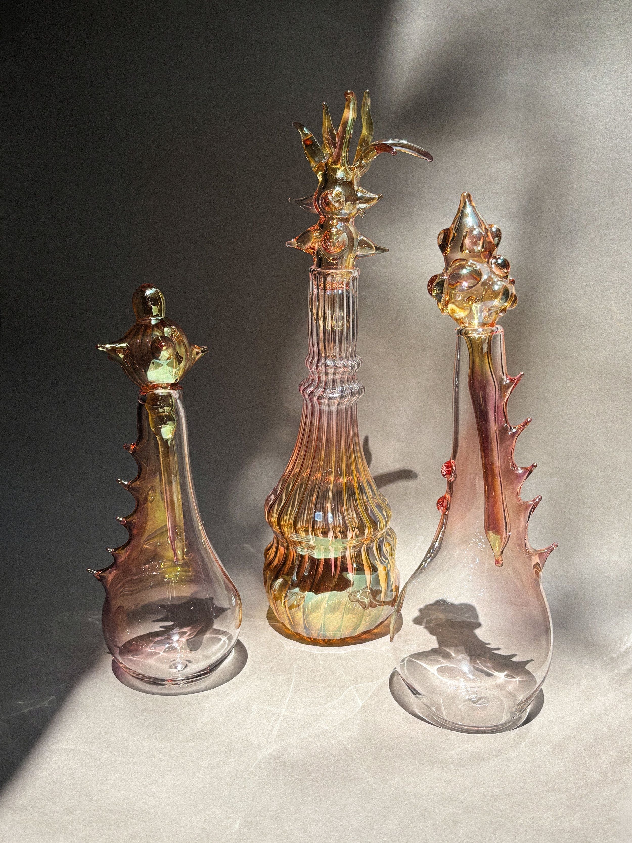 Perfumero Gloriosa Sculptures in Glass — trio of colorful glass vases on gray backdrop
