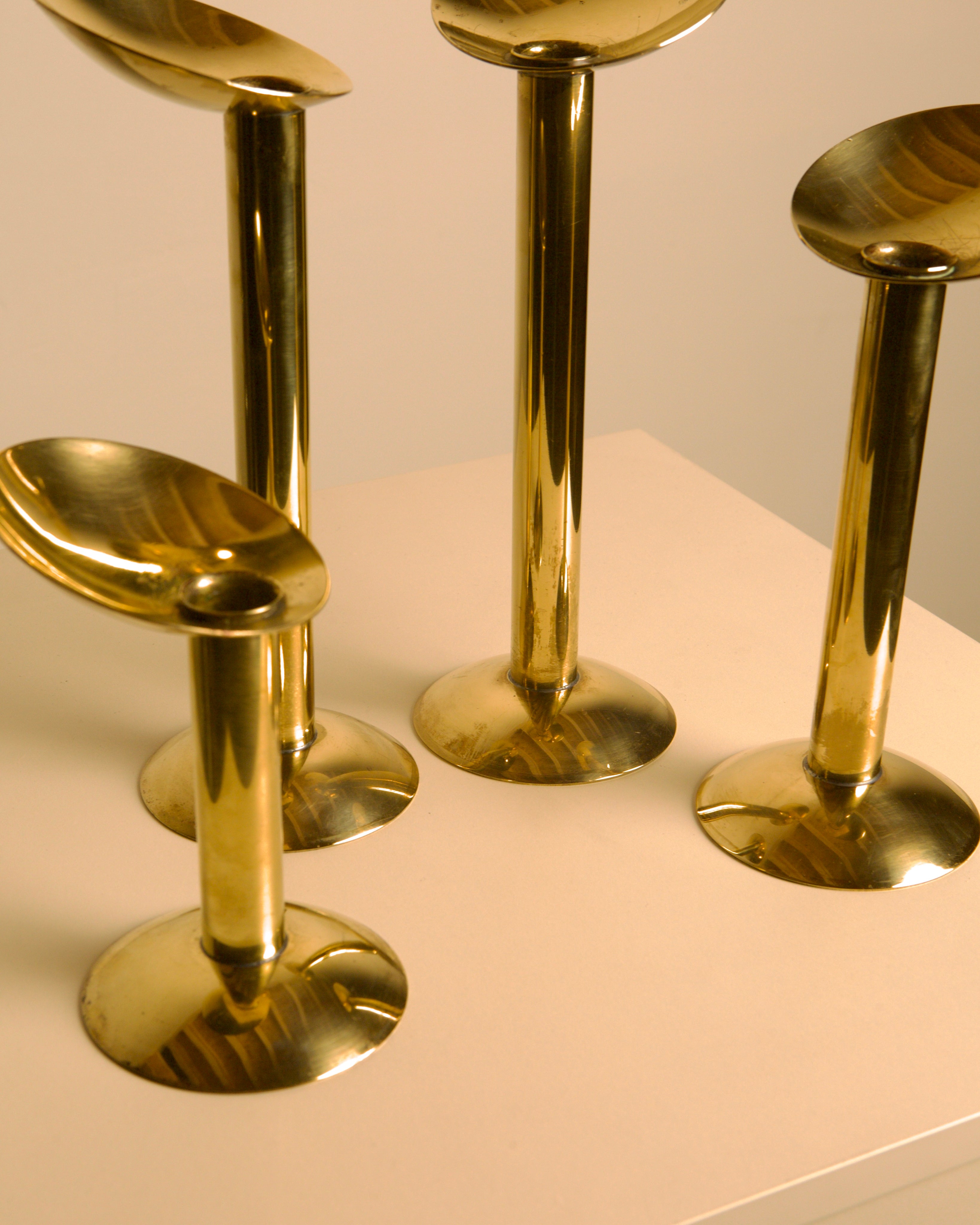 Set of 4 Danish brass candlesticks from the 1960s — lifestyle setting