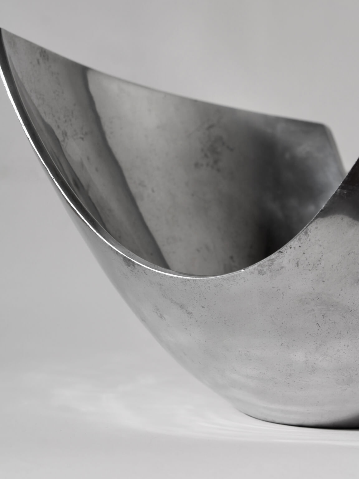 Polished Aluminum Asymmetric Contemporary Large Deep Bowl — side angle showing reflective surface