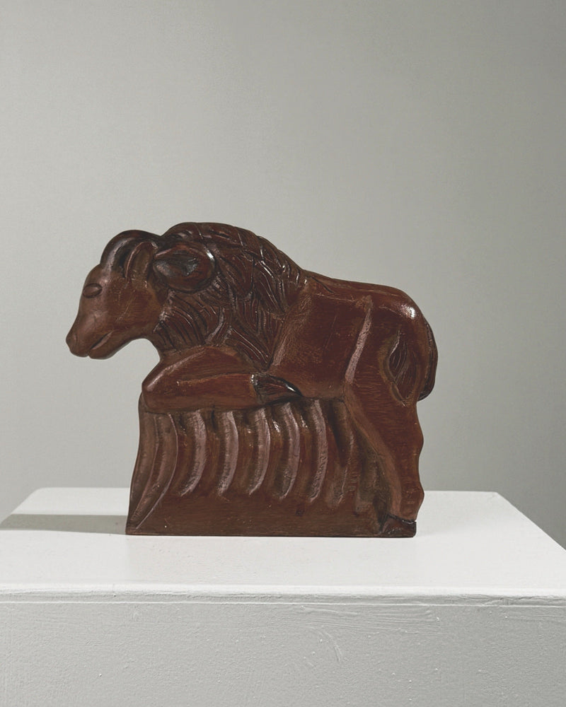 Carved wood ram sculpture in reclining position, late 19th century