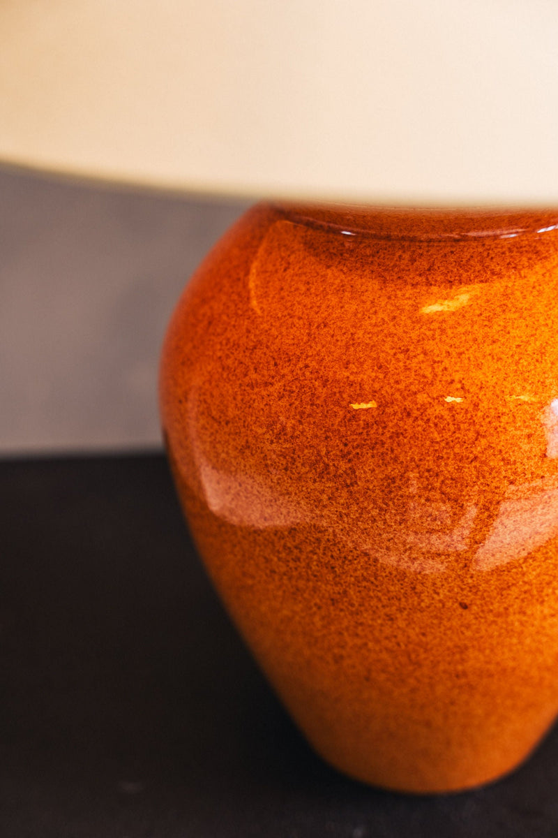 Orange ceramic table lamp close-up detail showing textured glaze