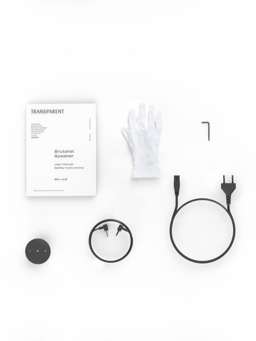 Brutalist Speaker Black — top view with accessories and manual on white background