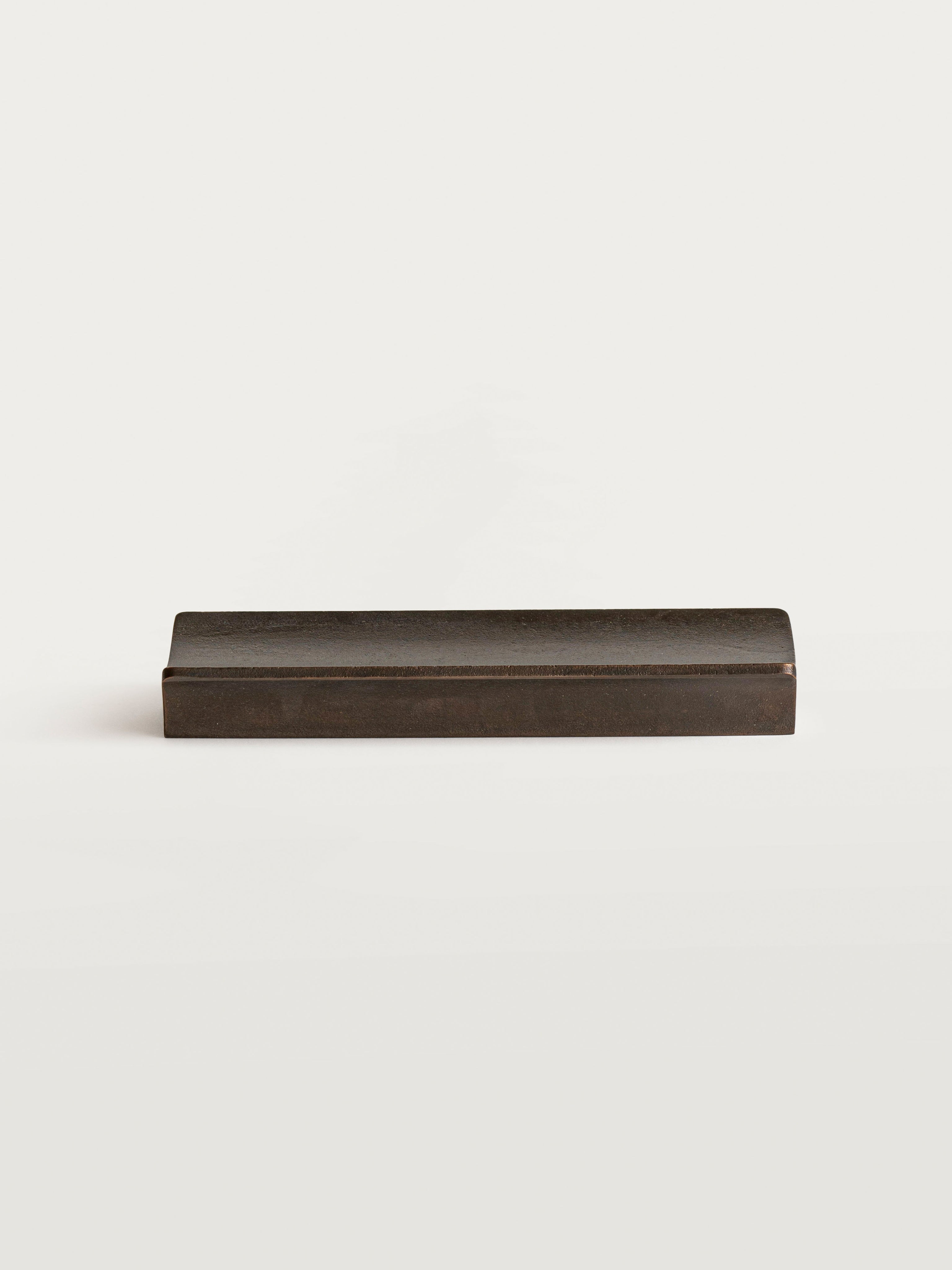 Arc Pen Tray — top view of dark metal design on white background