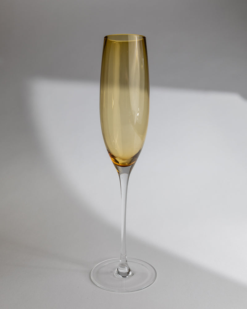 Single amber Murano glass champagne flute with clear stem detail