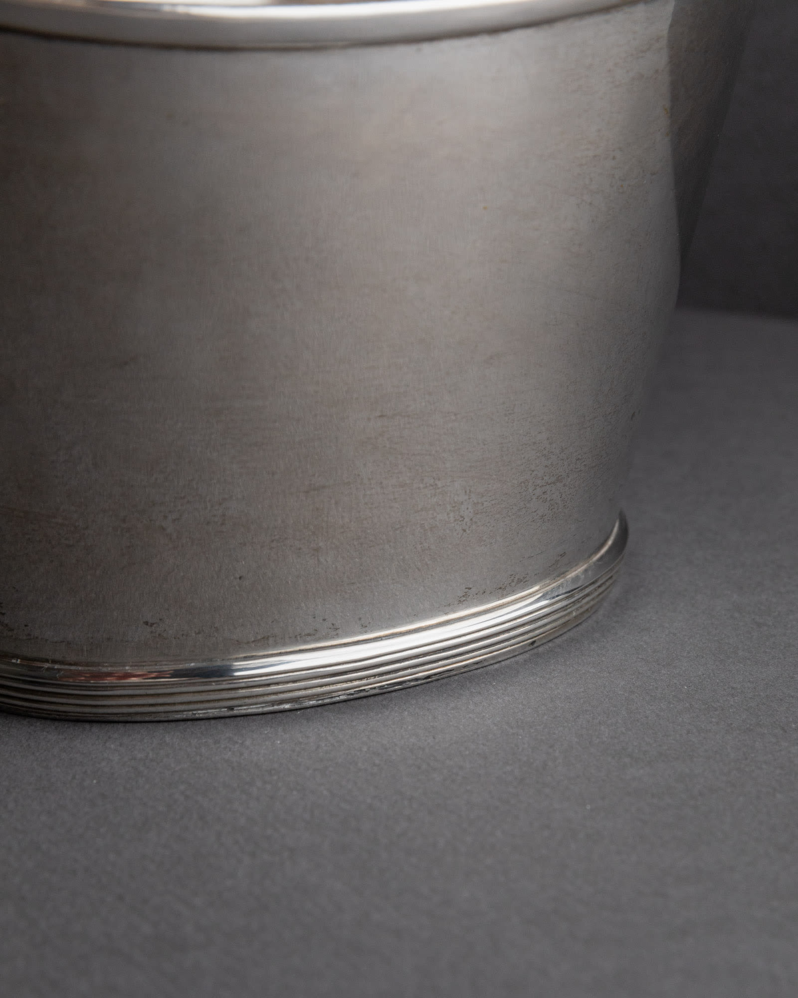 Vintage 1940s Silver Plated Champagne Cooler, Classic Form for Wine or Drinks — close-up of polished silver surface on gray b