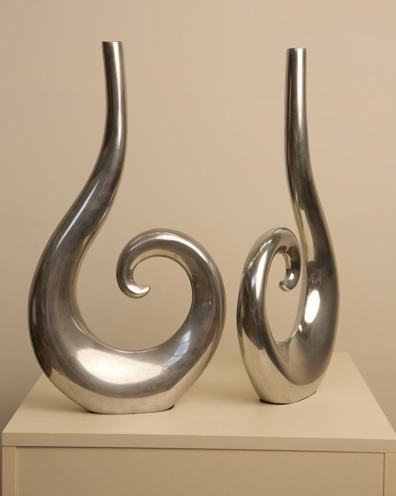 Curved aluminum vases pair showing sculptural spiral design detail