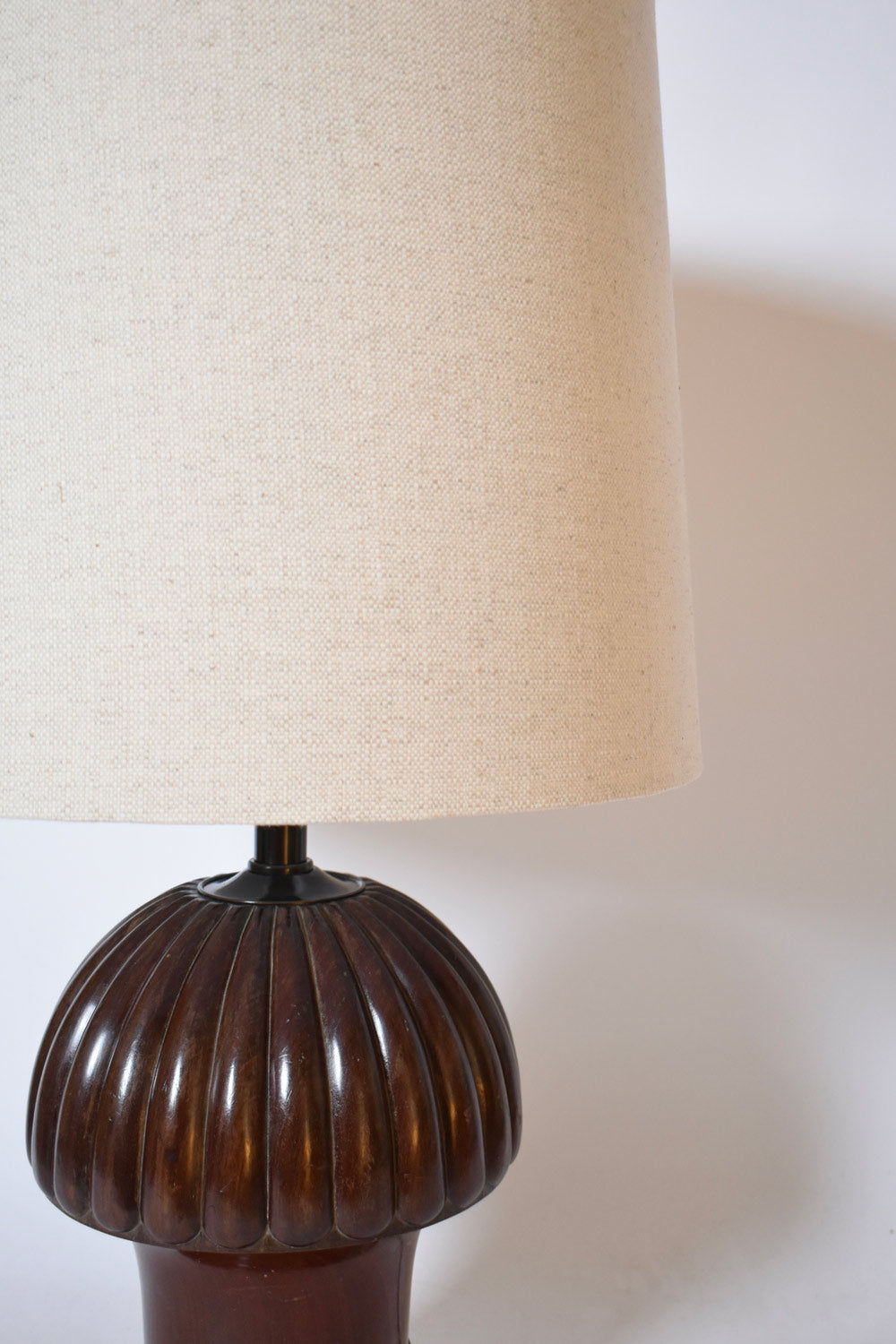 A close-up of Barracuda Interiors' Pine Shape Wooden Lamp, 1930s, showcases its ribbed dark brown base and large textured beige shade in vintage style against a plain white background.