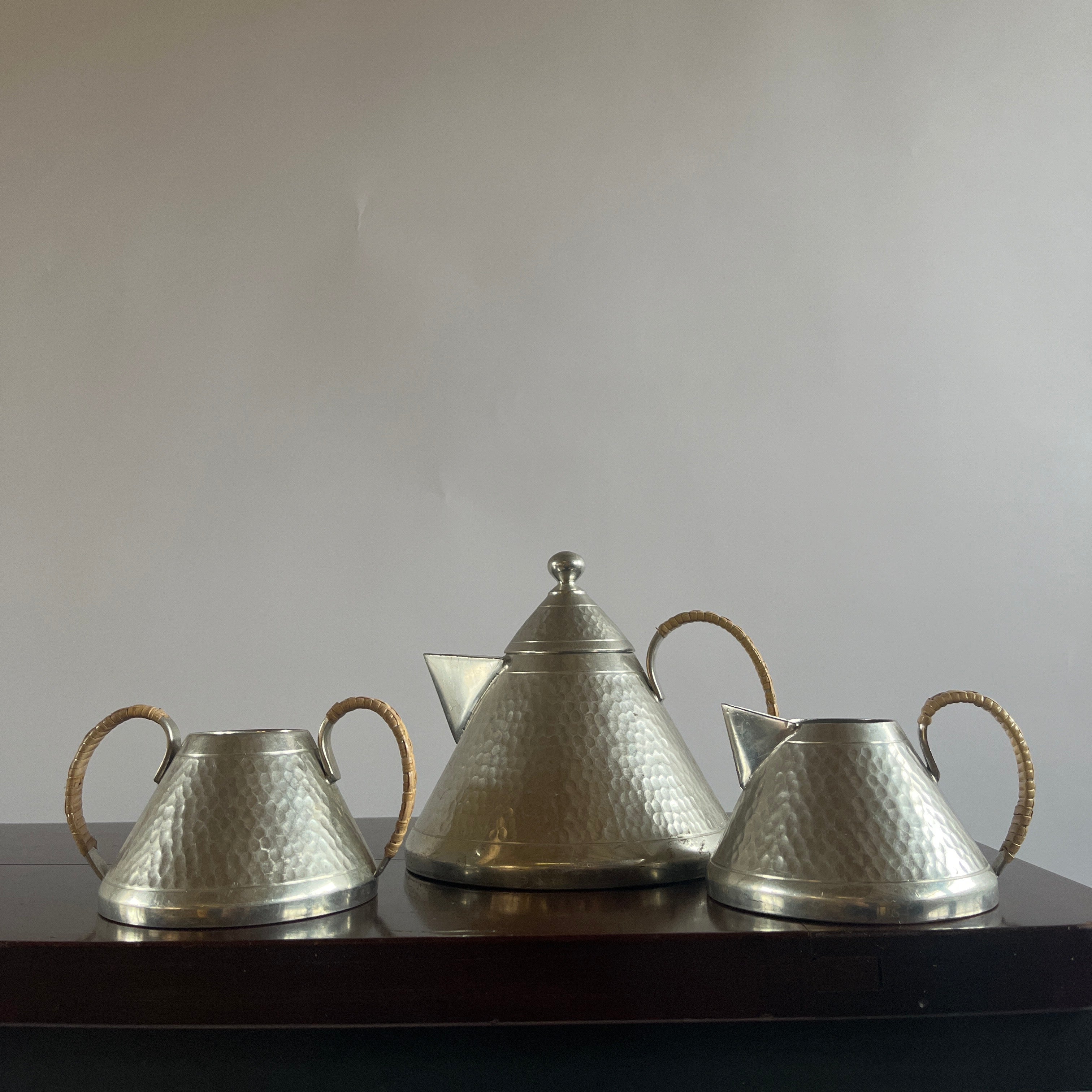 Art Deco Hammered Pewter Tea Set — side angle on dark wood table