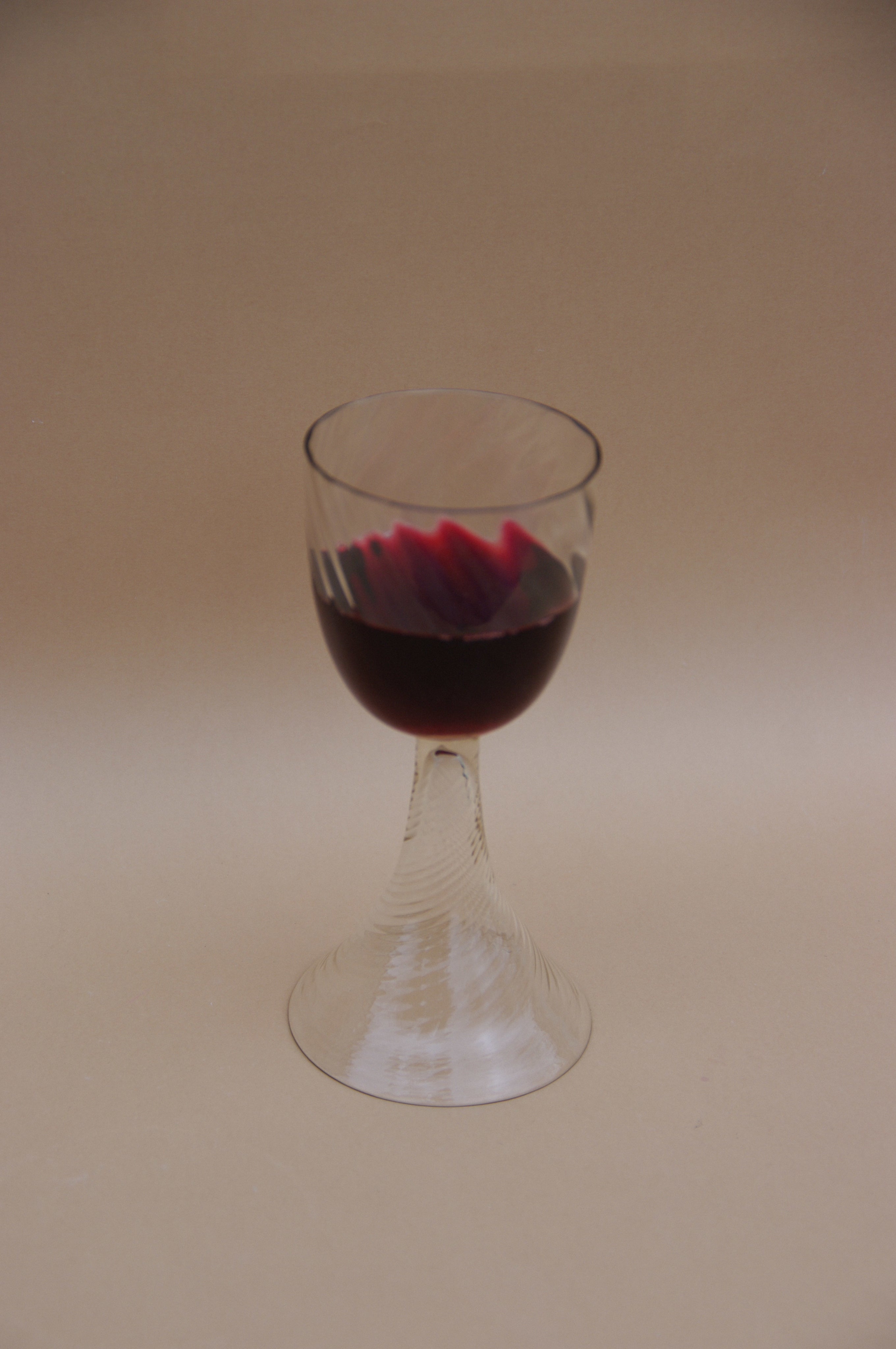 Pair of Mouthblown Wine Goblets in glass — side view with red wine