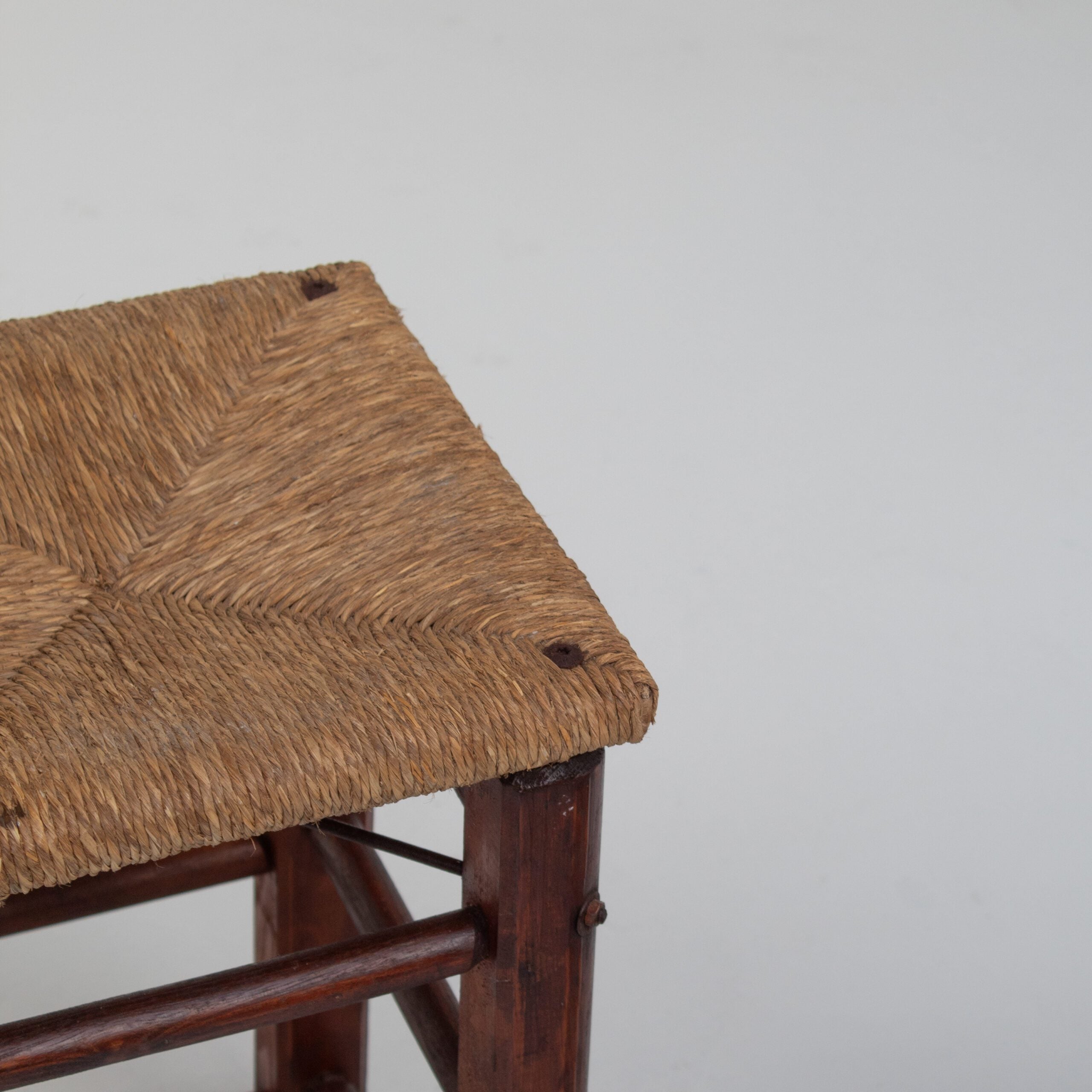 Pair of Rustic Wooden Stools with Woven Rush Seats — close-up of woven rush seat