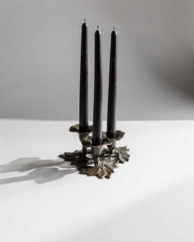 Bronze floral candleholder with three black tapers by Christiansen