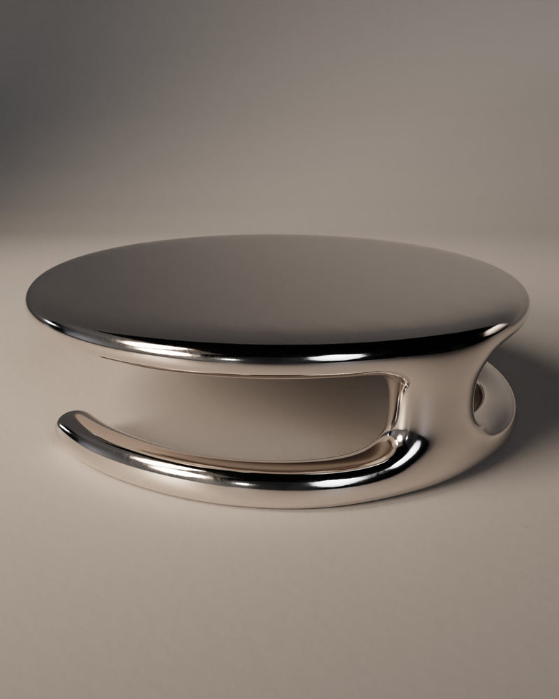 SOMNIA aluminum low table with curved reflective base and black top