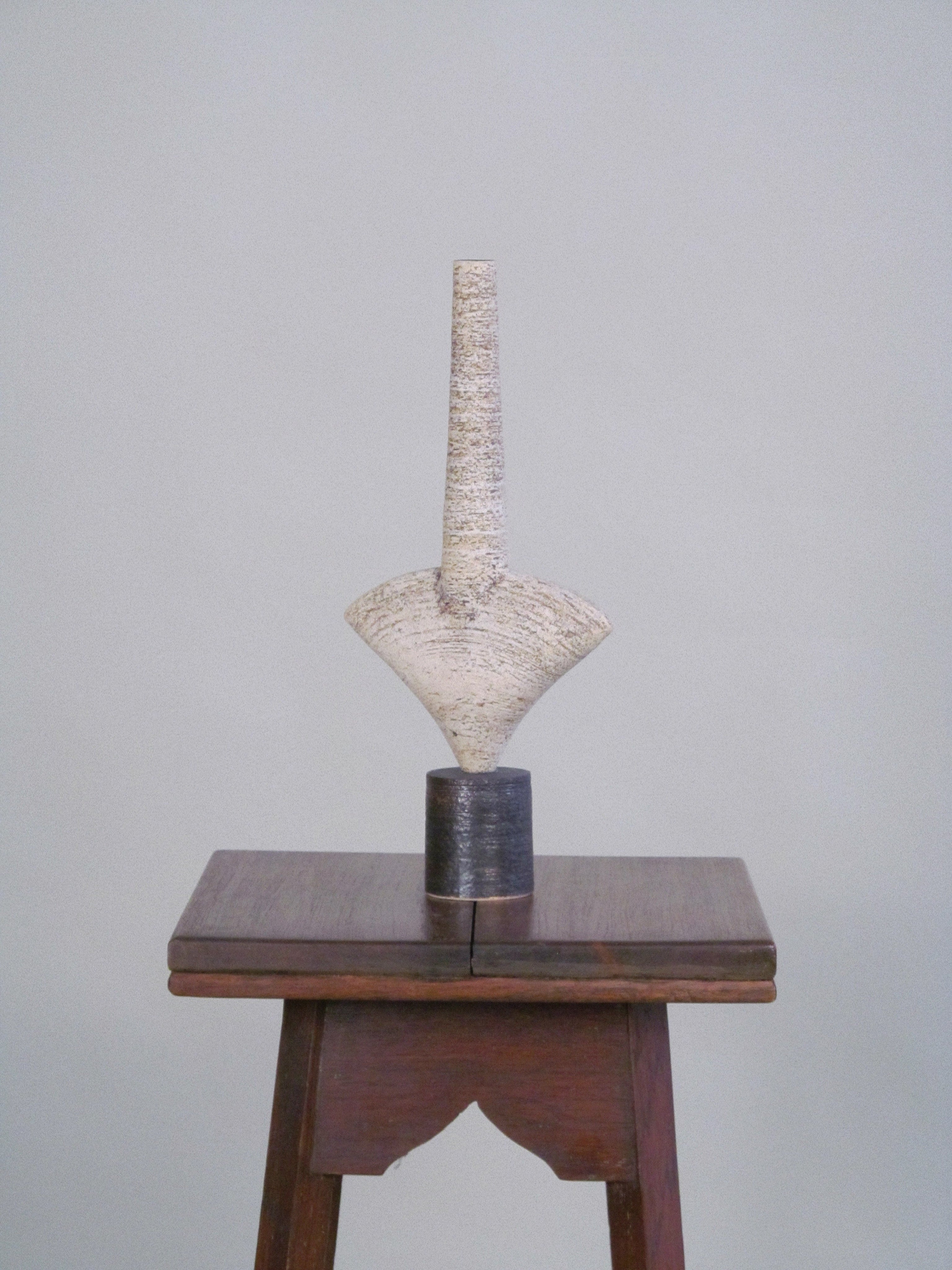 Pair of Dameon Lynn Ceramic Forms — side angle on wooden pedestal