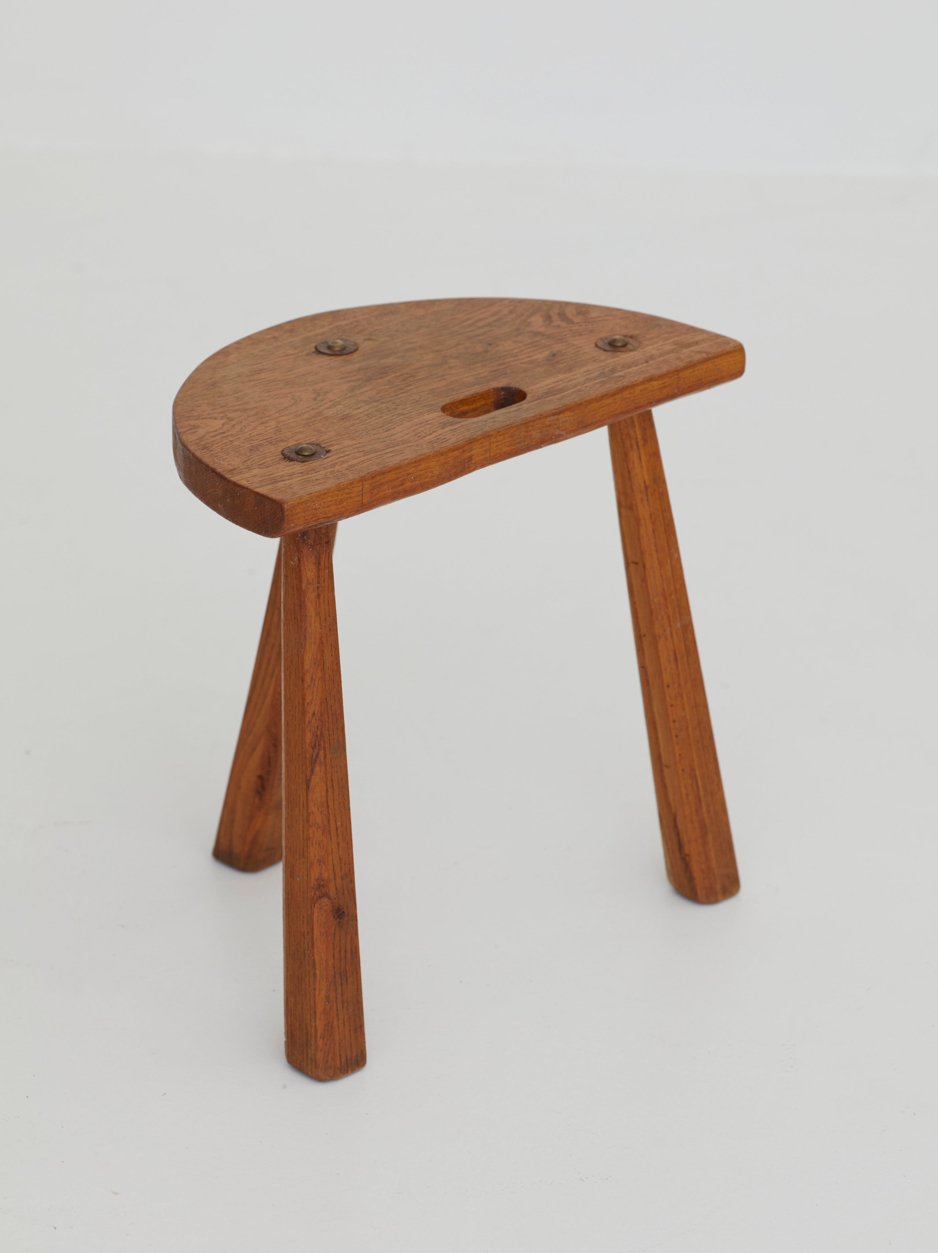 Two French Artisanal Solid Wood Half-moon Tripod Stools, Circa 1950 — side angle showing wooden seat and legs