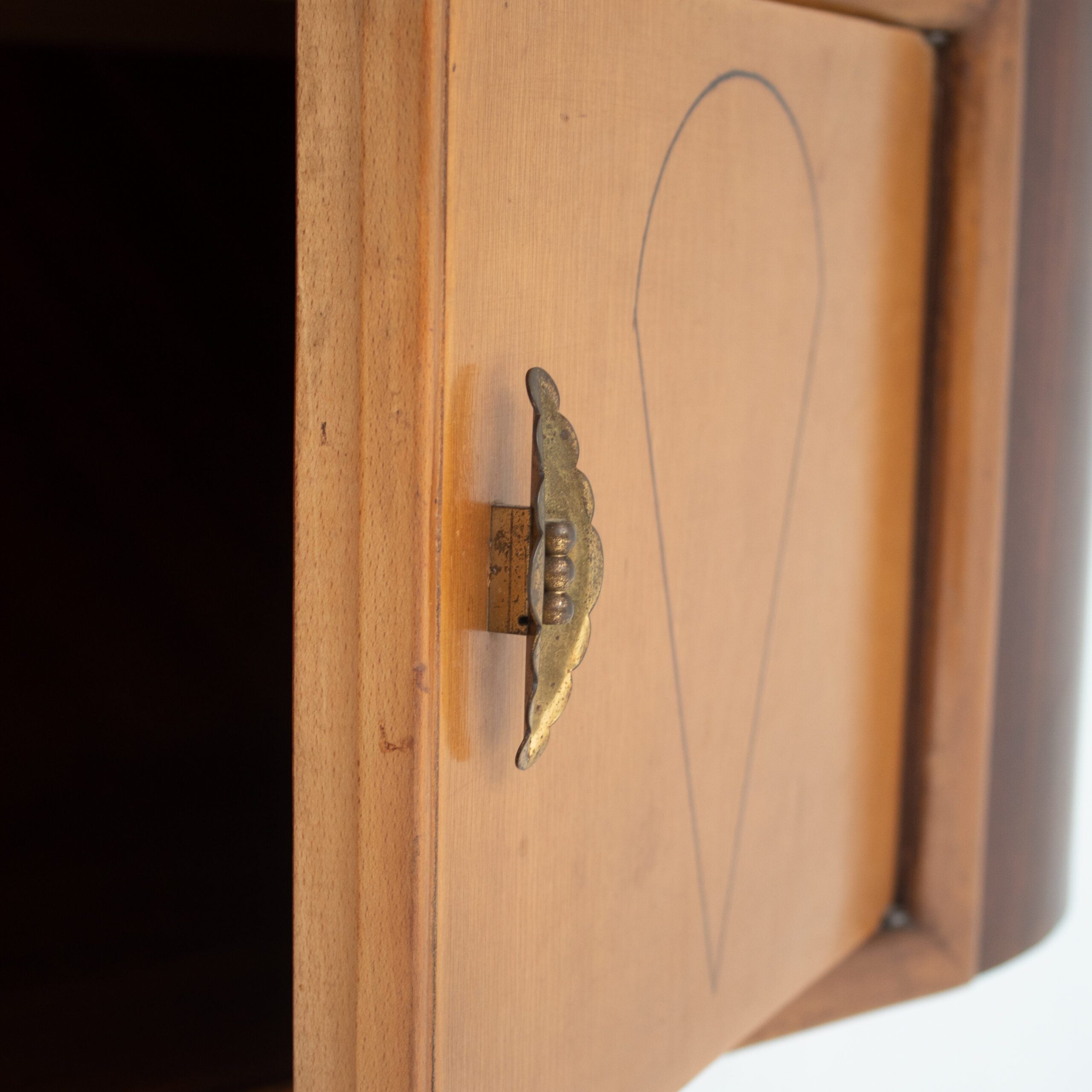 Art Deco Walnut Console with Inlay Details — close-up of brass handle on cabinet door