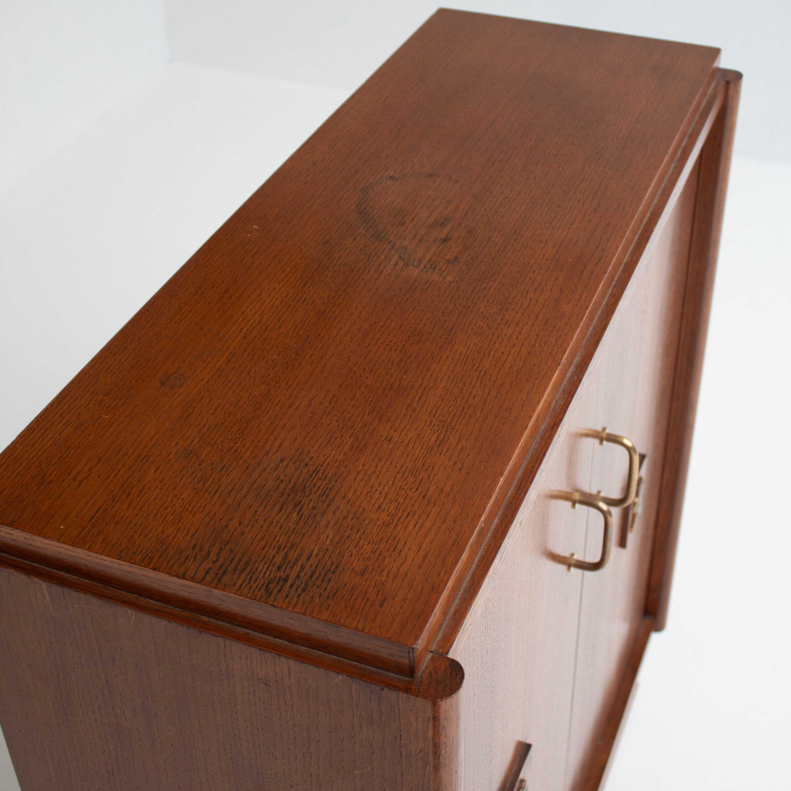 Mid-Century Oak Cabinet with Brass Handles and Decorative Inlays — in context