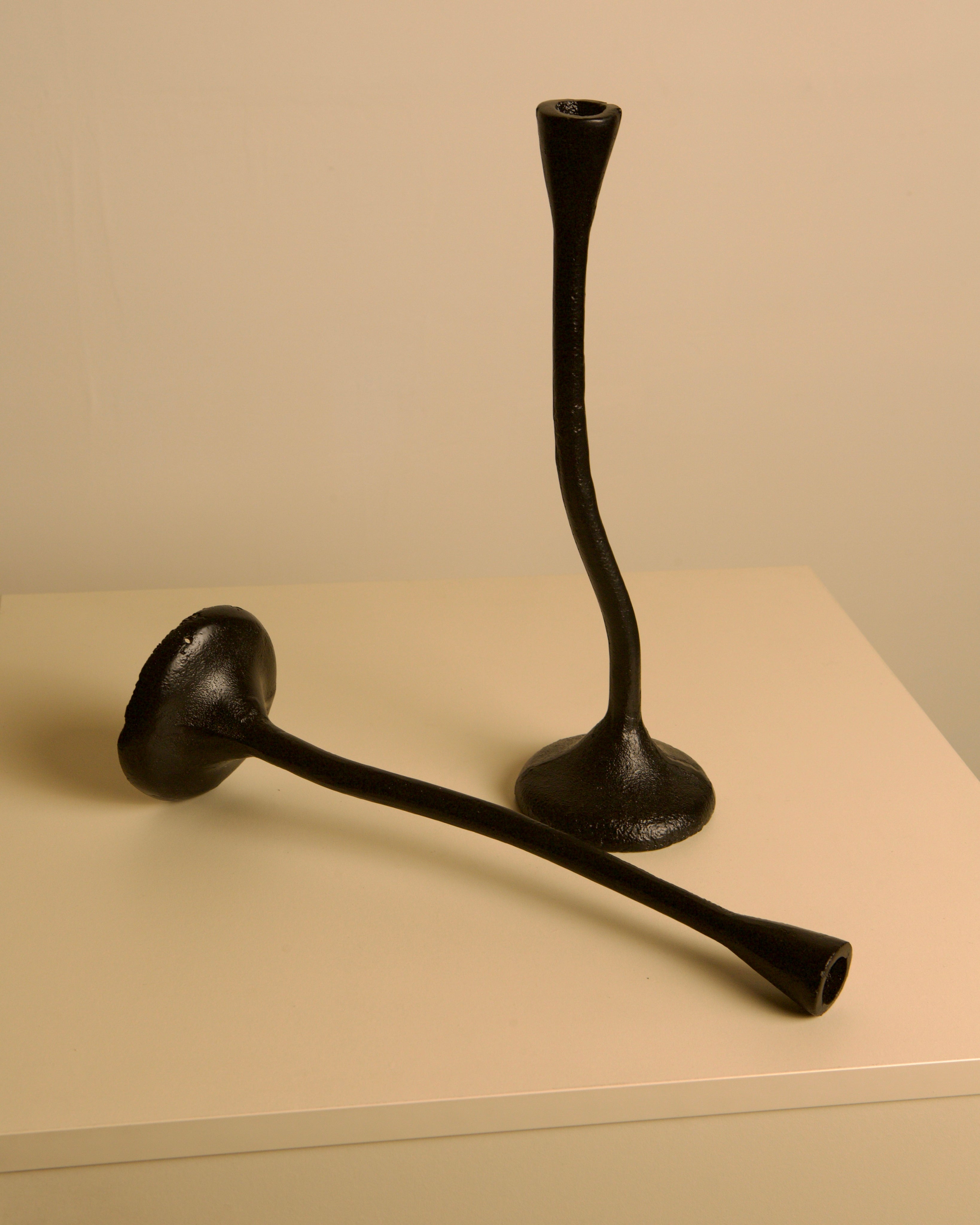Pair of "Torsadé" Candleholders in Black Cast Aluminum from the 80s — close-up showing textured black surface on neutral back