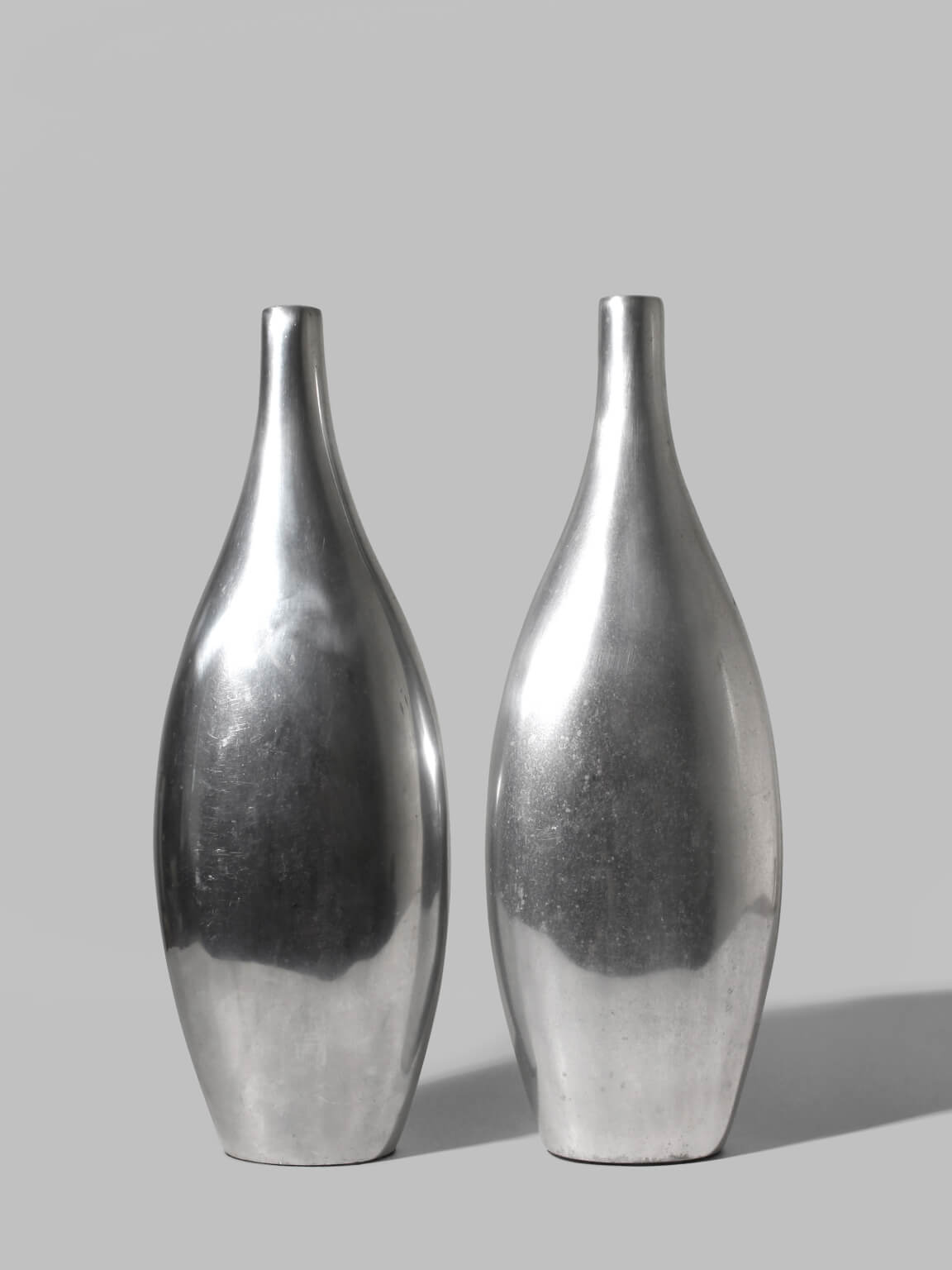 Pair Of Polished Aluminum Tall Vases by Vintage Stories | The Oblist